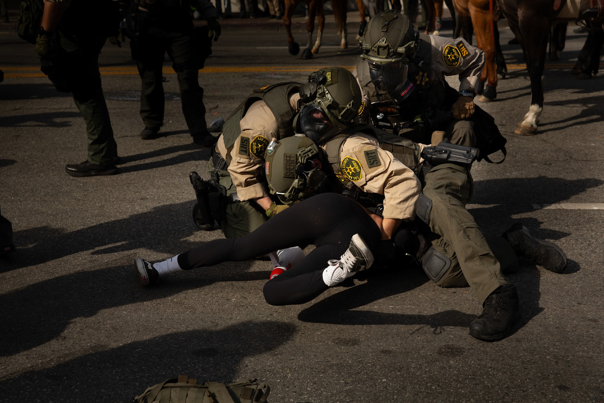 Los Angeles County Shriffs tackle a demonstrator during a march against the Trump Military Parade and immigration raids by ICE in Downtown Los Angeles on June 13, 2025