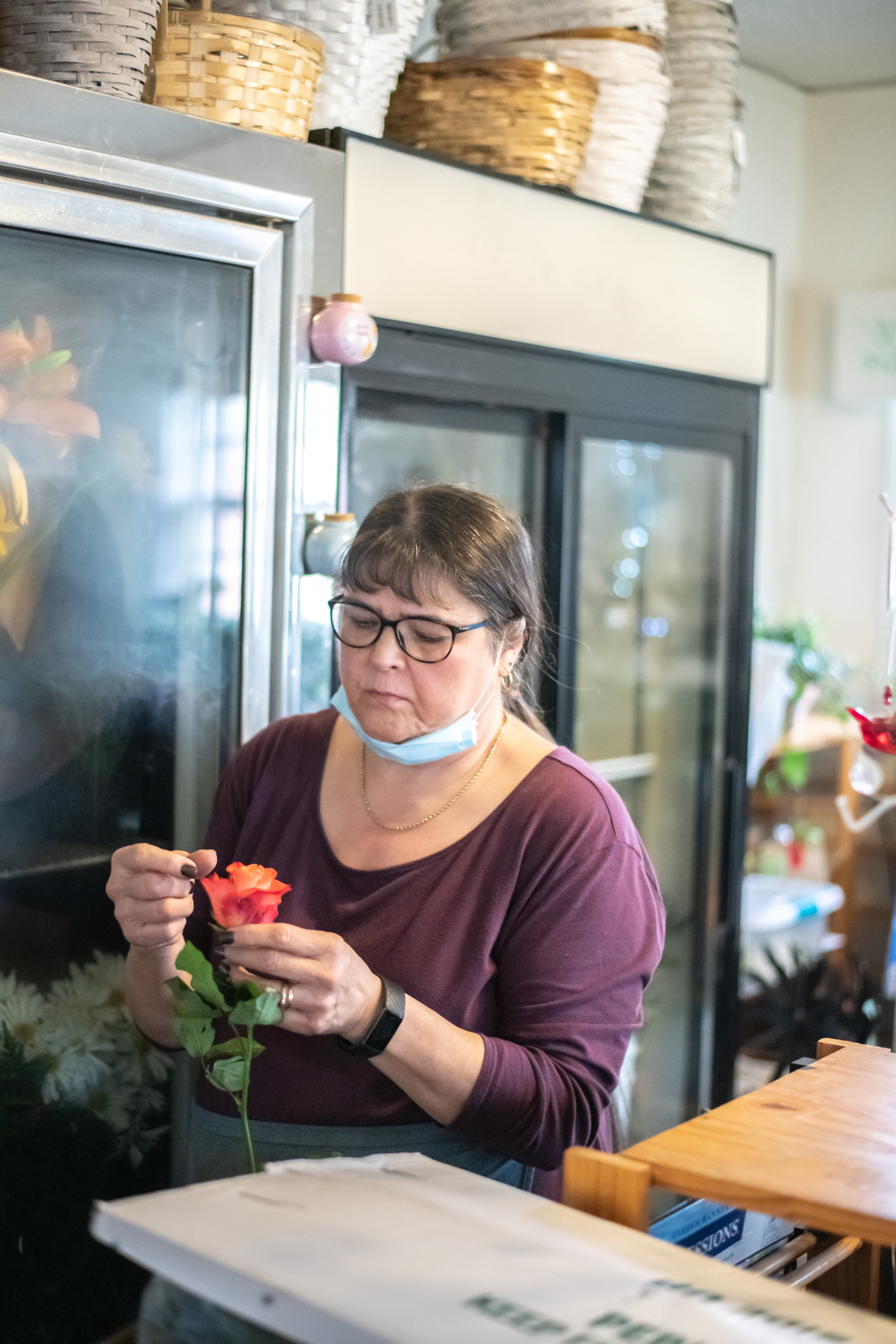 Becky Bevan looks over a flower pulled from the cooler at Always In Bloom Florist in Archdale, N.C. on November 25, 2020.