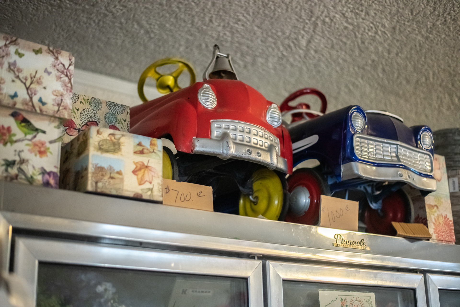 Pedal cars sit atop a cooler at Always In Bloom Florist in Archdale, N.C. on November 25, 2020.