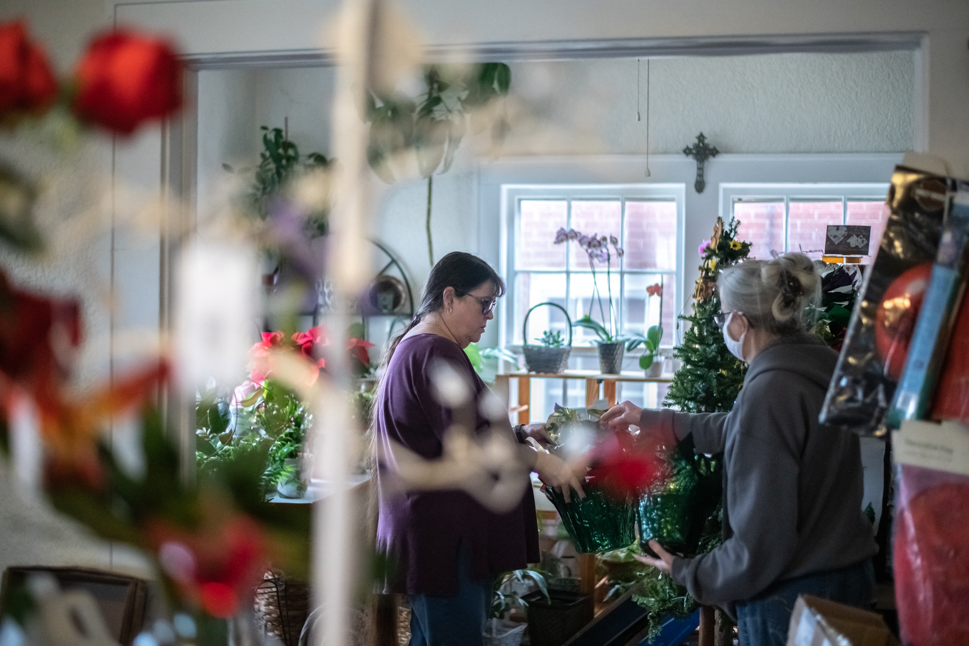 Becky Bevan (left) and Brenda Allred prepare poinsettas for sale at Always In Bloom Florist in Archdale, N.C. on November 25, 2020.