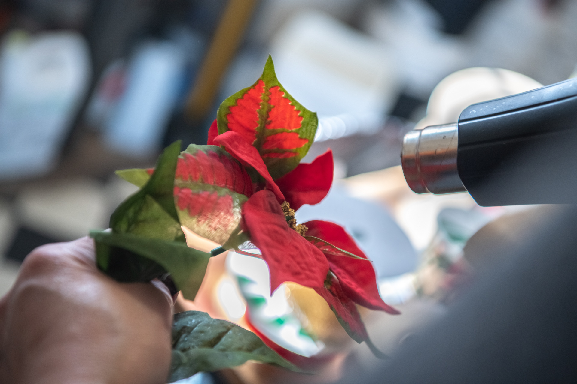 Becky Bevan uses a heat gun to refresh an old silk flower for an arrangement at Always In Bloom Florist in Archdale, N.C. on November 28, 2020.