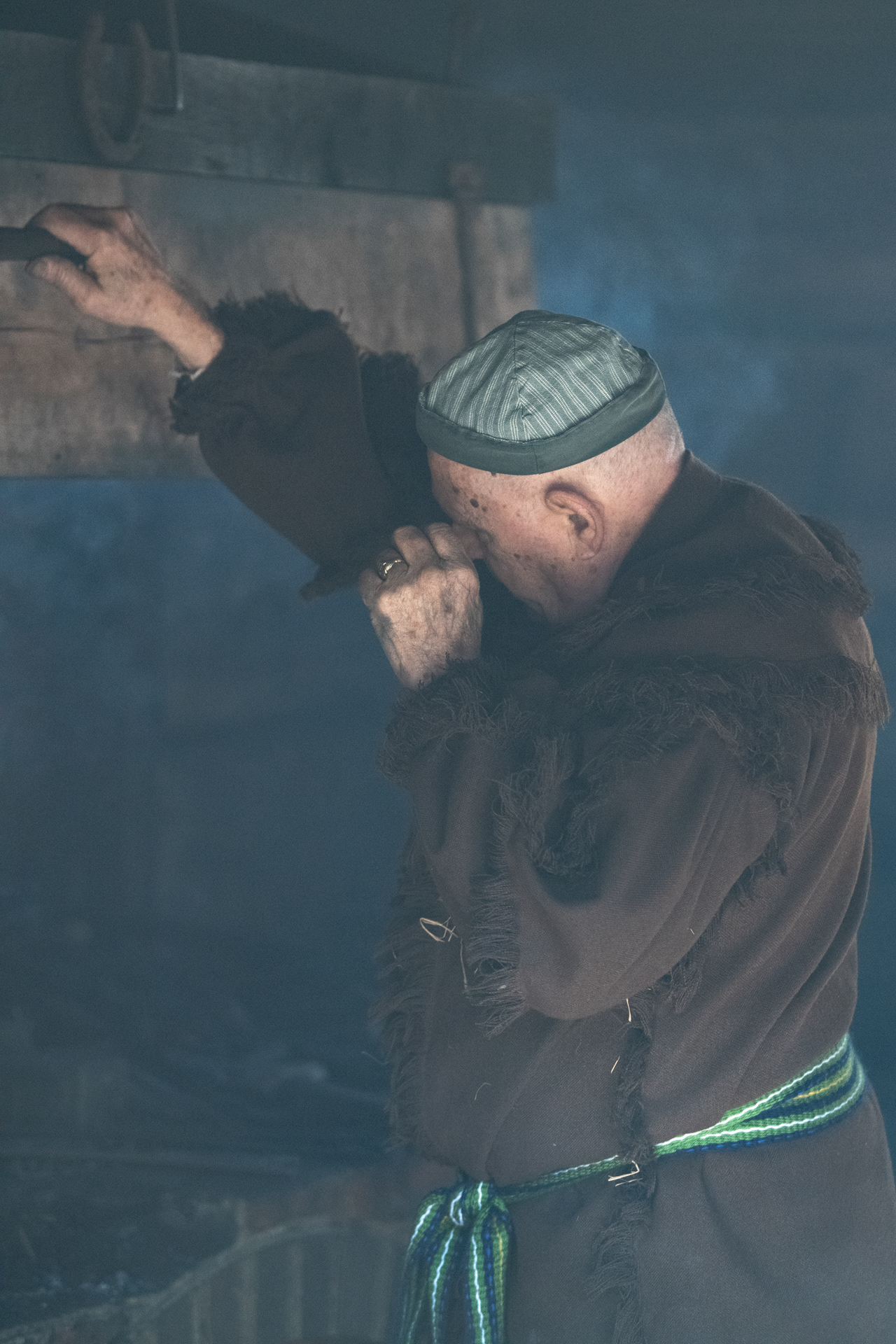 Jimmy Campbell wipes his eye as he tends to the forge at the Historical Park operated by the High Point Museum in High Point, N.C. on January 