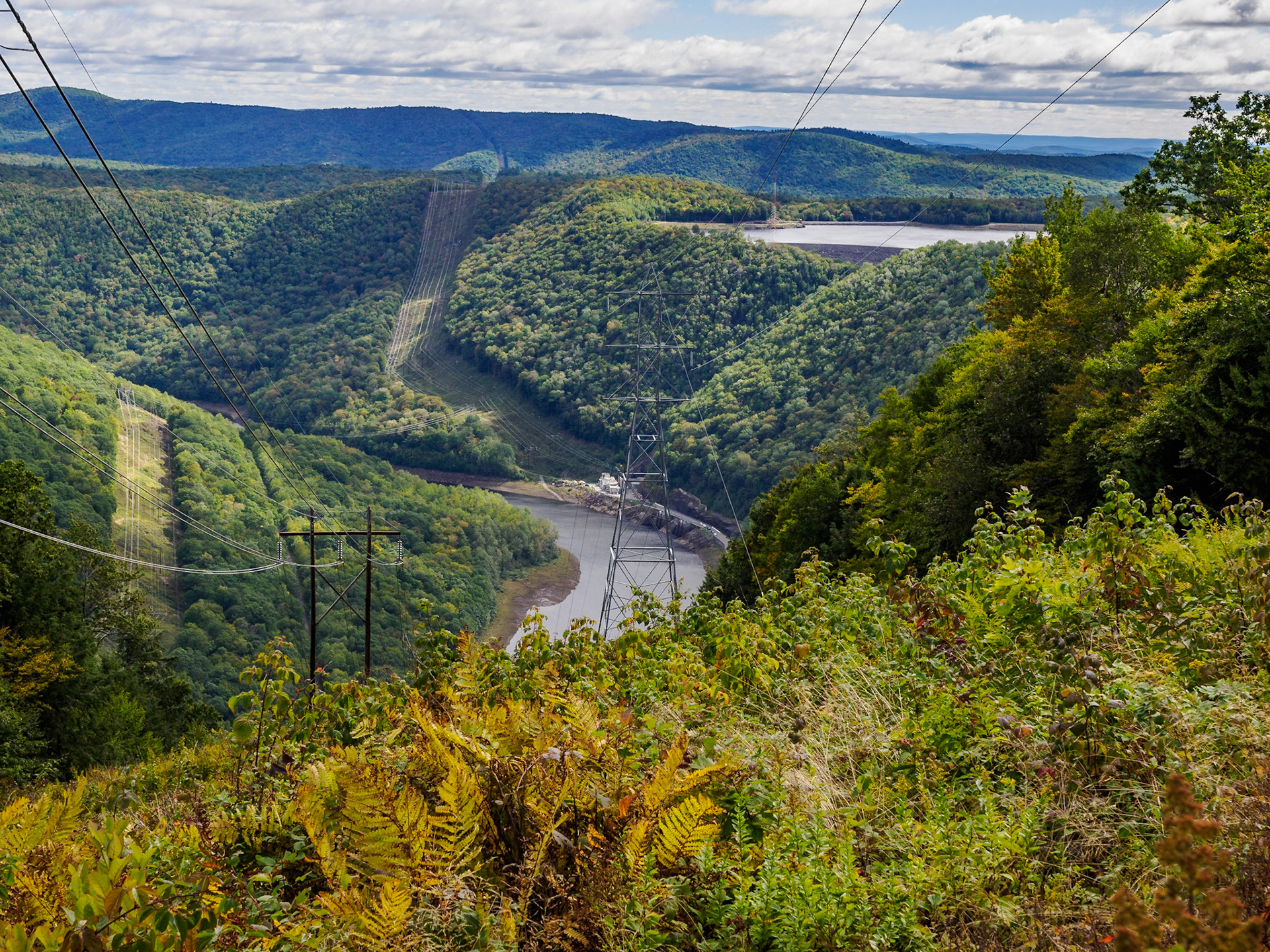 This was an unexpected find along the trail–Transmission lines in the foreground and background lead to a 600 MW pumped hydro plant. The body of water near the top right of the photos is the upper reservoir and the water below is the lower reservoir. It was interesting to see both reservoirs of a pumped hydro plant so close to each other. Perhaps you need to be a DOUG (dumb old utility guy or gal) to find this interesting.