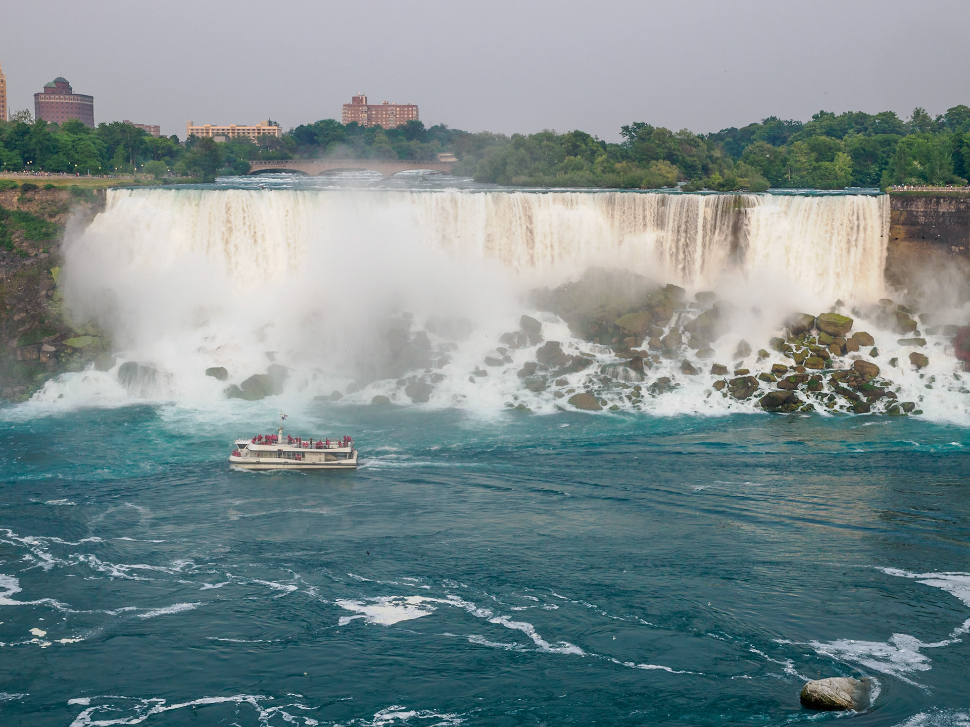 American Falls with boat coming back from up-close look at Horseshoe Falls on Canadian side of Niagara Falls