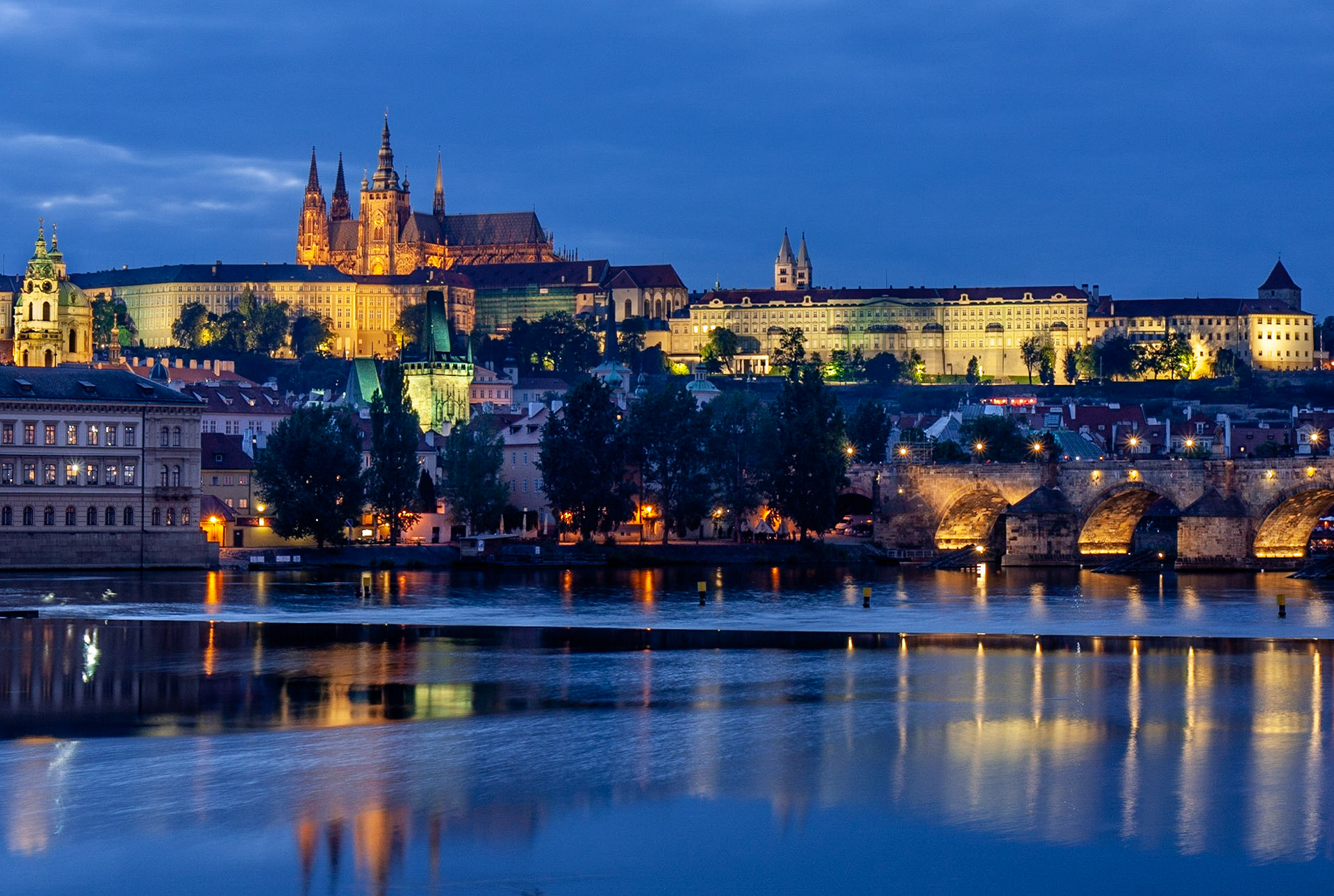 Looking across the Vltava River, the castle and Lesser Town are lit up at night