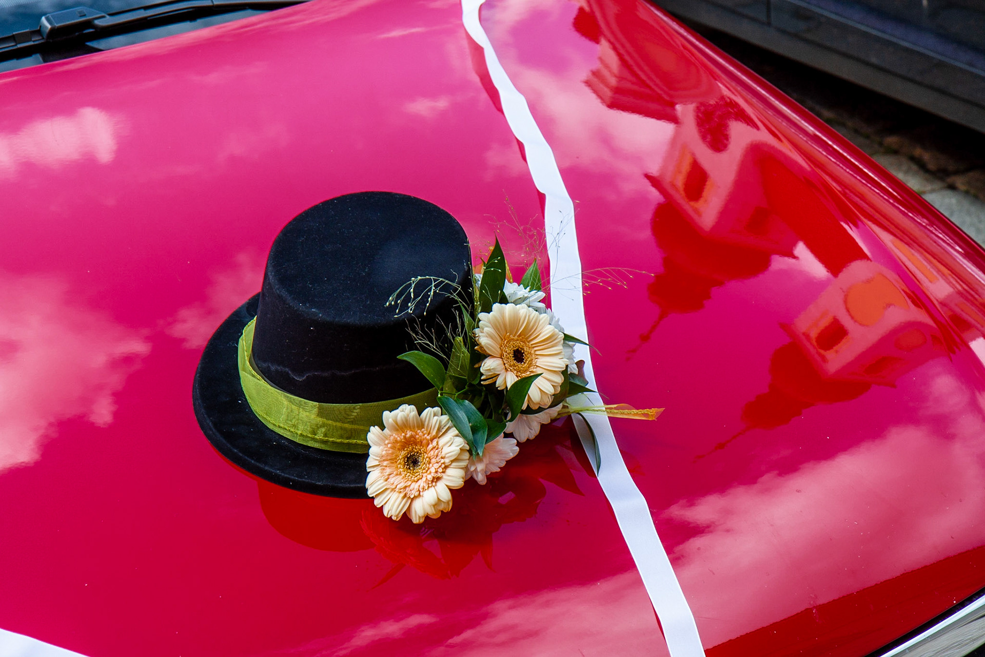 Wedding tradition of attaching a hat on the car of the groom
