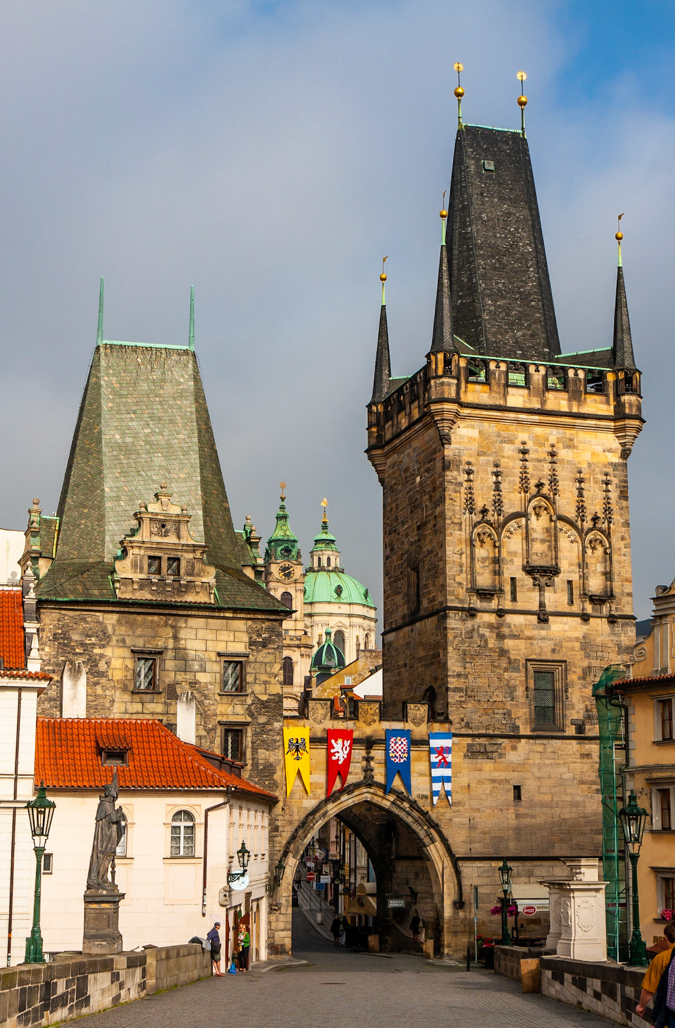 The green dome of the Church of St. Nicholas peeks between the towers