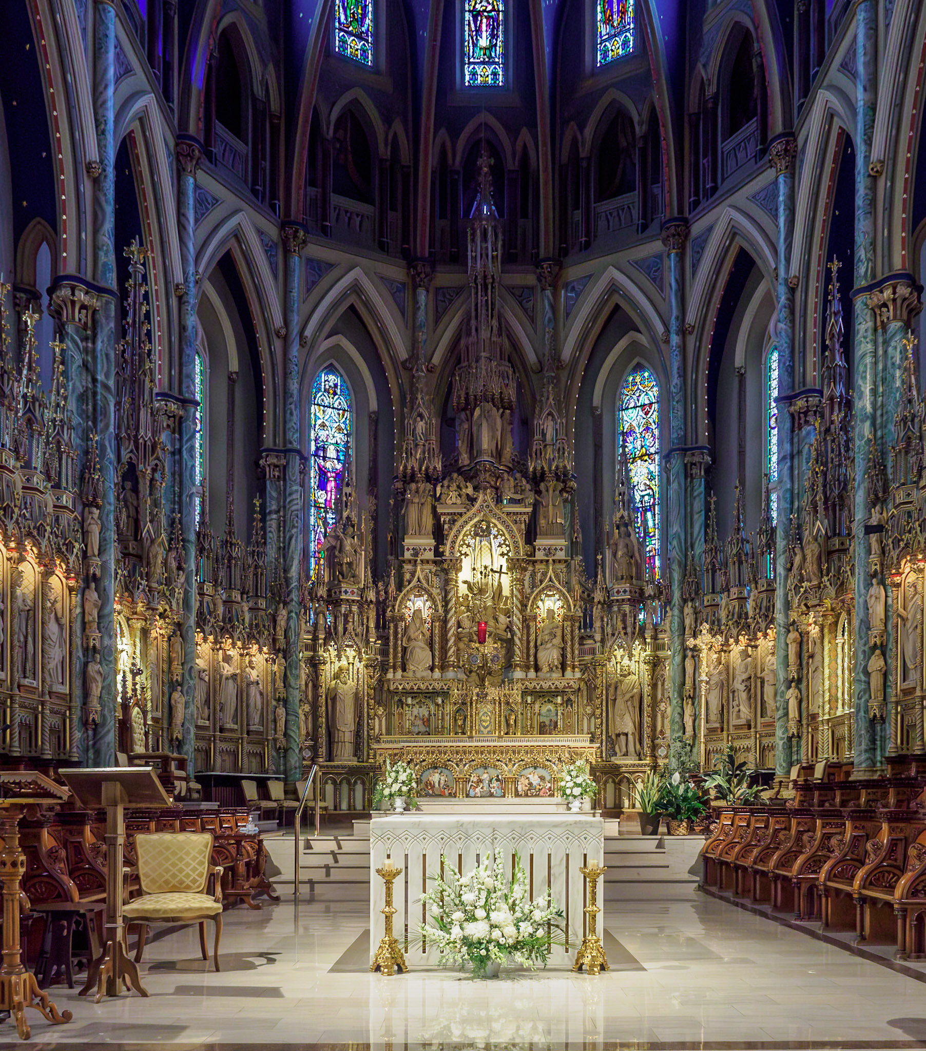 Apse area and altar. Lots of statues and stained glass.