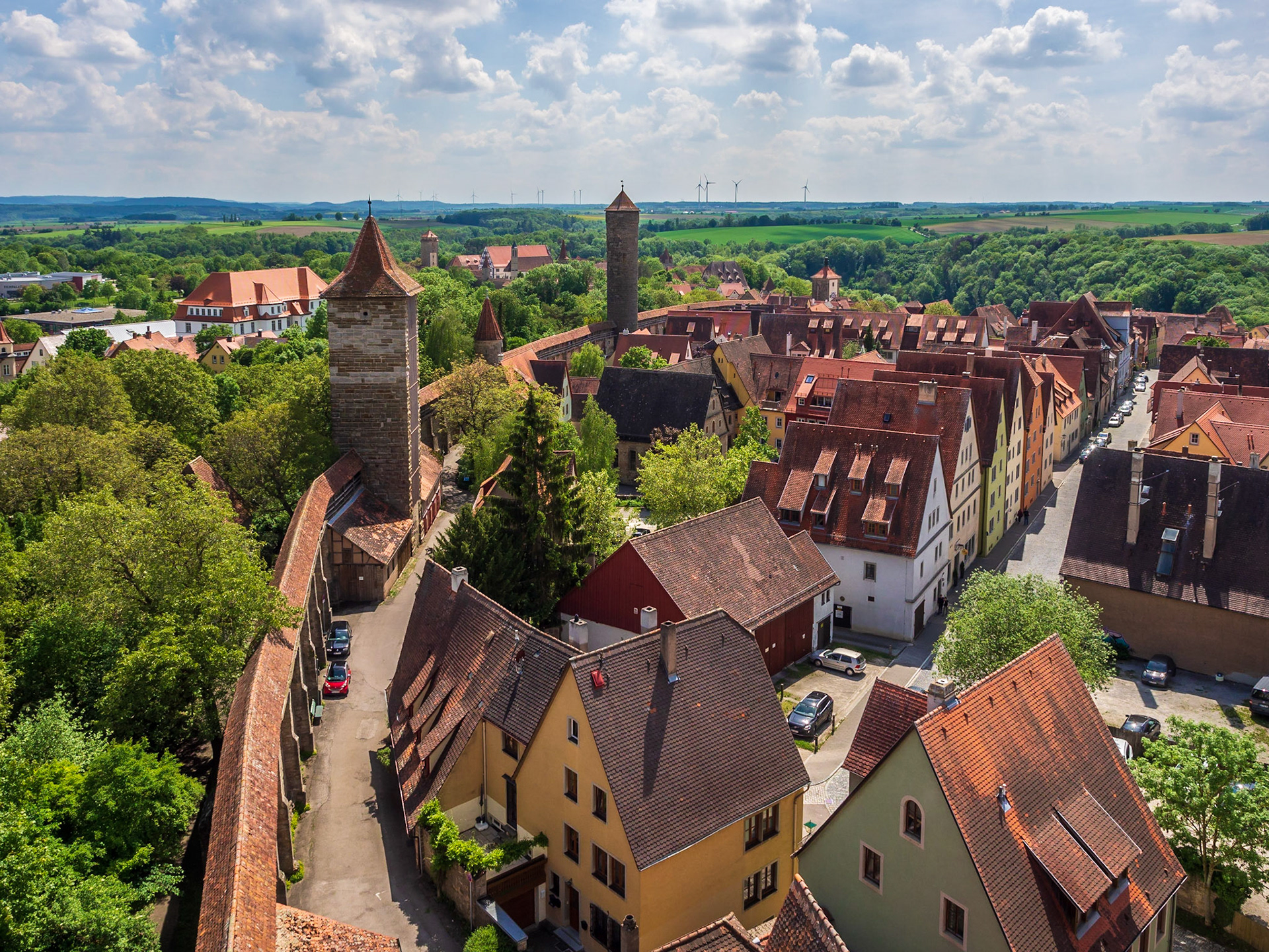 From the top of Röder Tower. New wind turbines in the distance contrast with the old walls of the city.