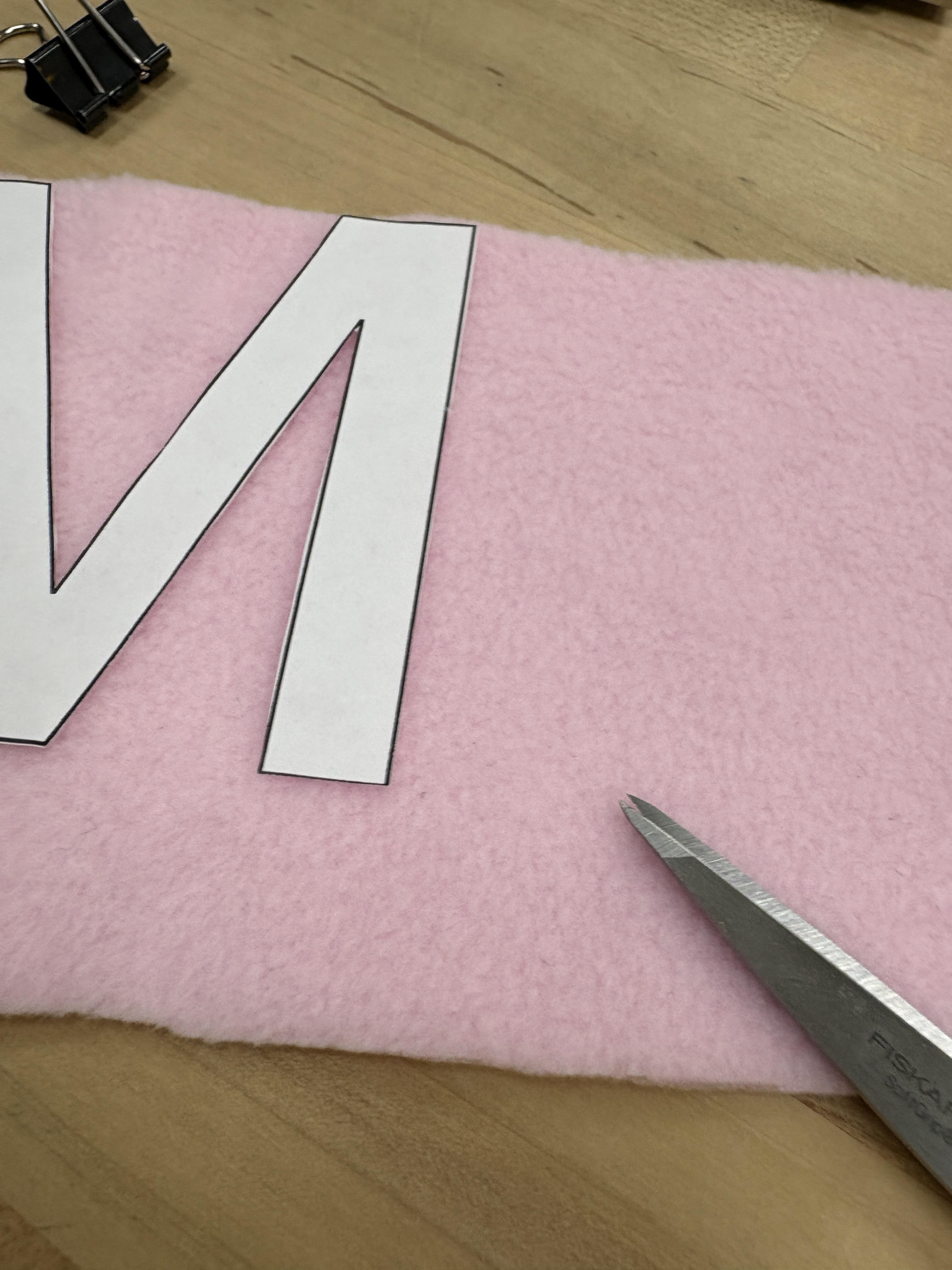 Line it up to the edge so it is easier to cut out the letters.