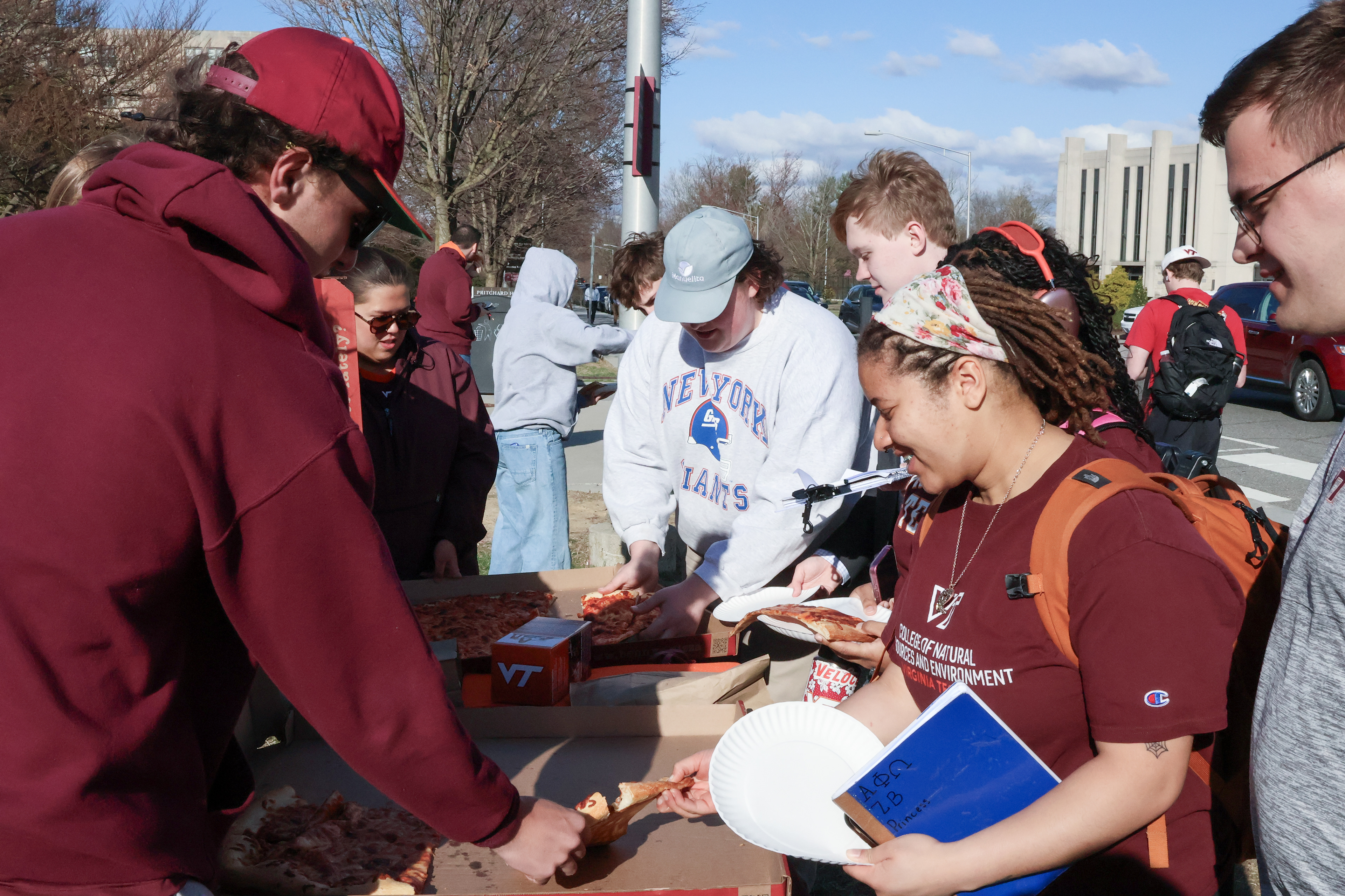 Students at the tailgate grabbing the Bennys Pizza.(Jackie Mitchell/JMC 4114)