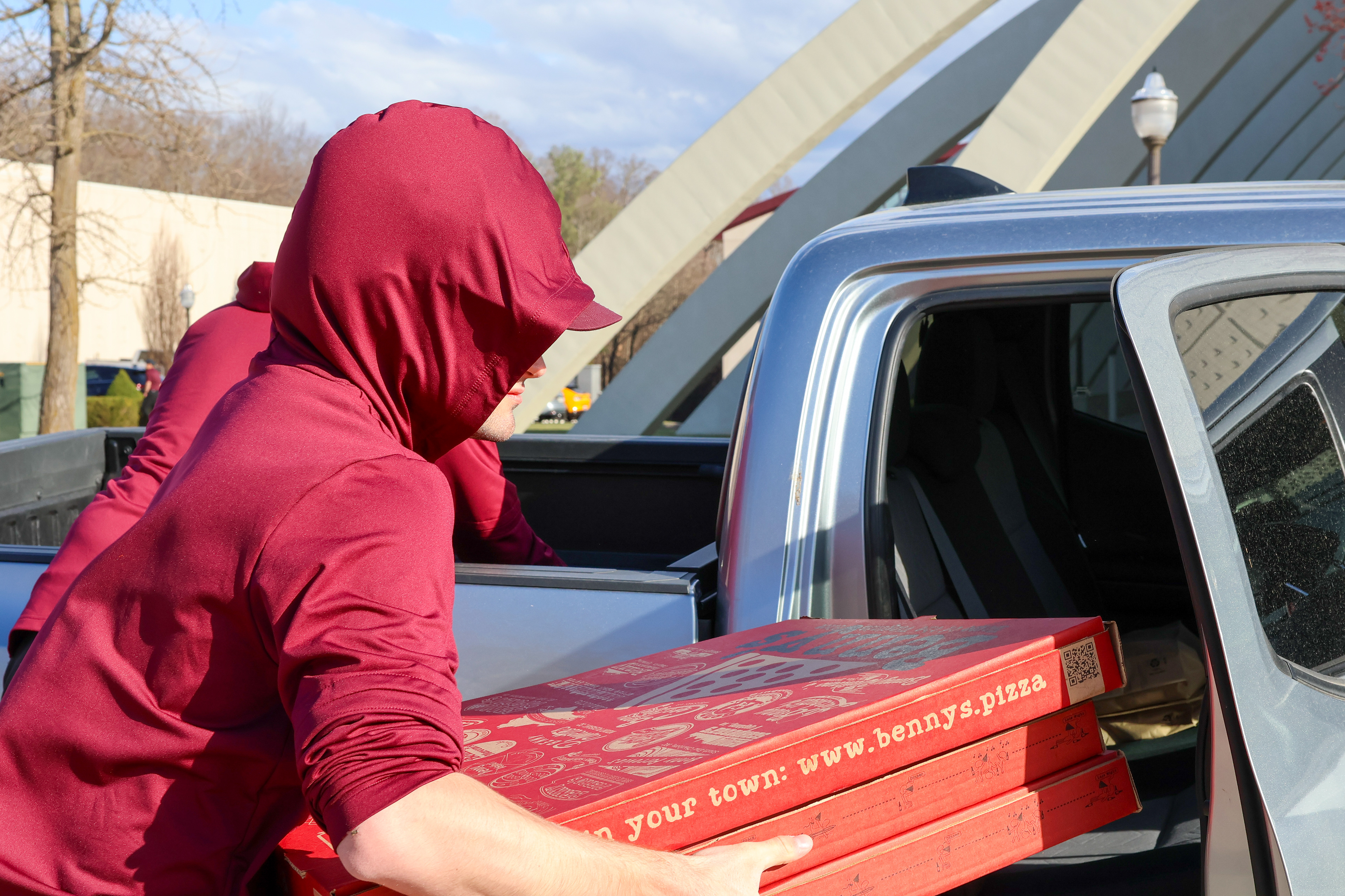 Hughes gathering the Bennys Pizza Box out of the car for the tailgate.(Jackie Mitchell/JMC 4114)
