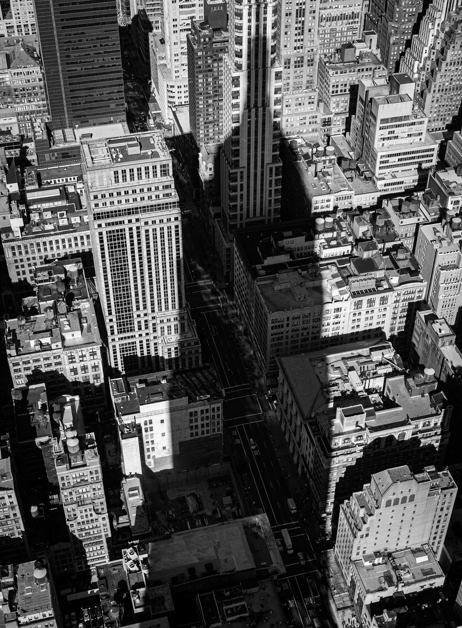 Viewed from the building's observation deck, the shadow of the Empire State Building imposes itself on smaller nearby buildings in Manhattan, New York, USA