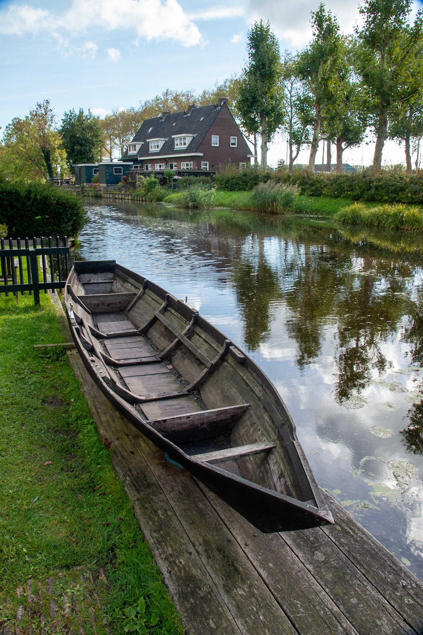 An old wooden canal boat on a dock at Zaanse Schans, Netherlands