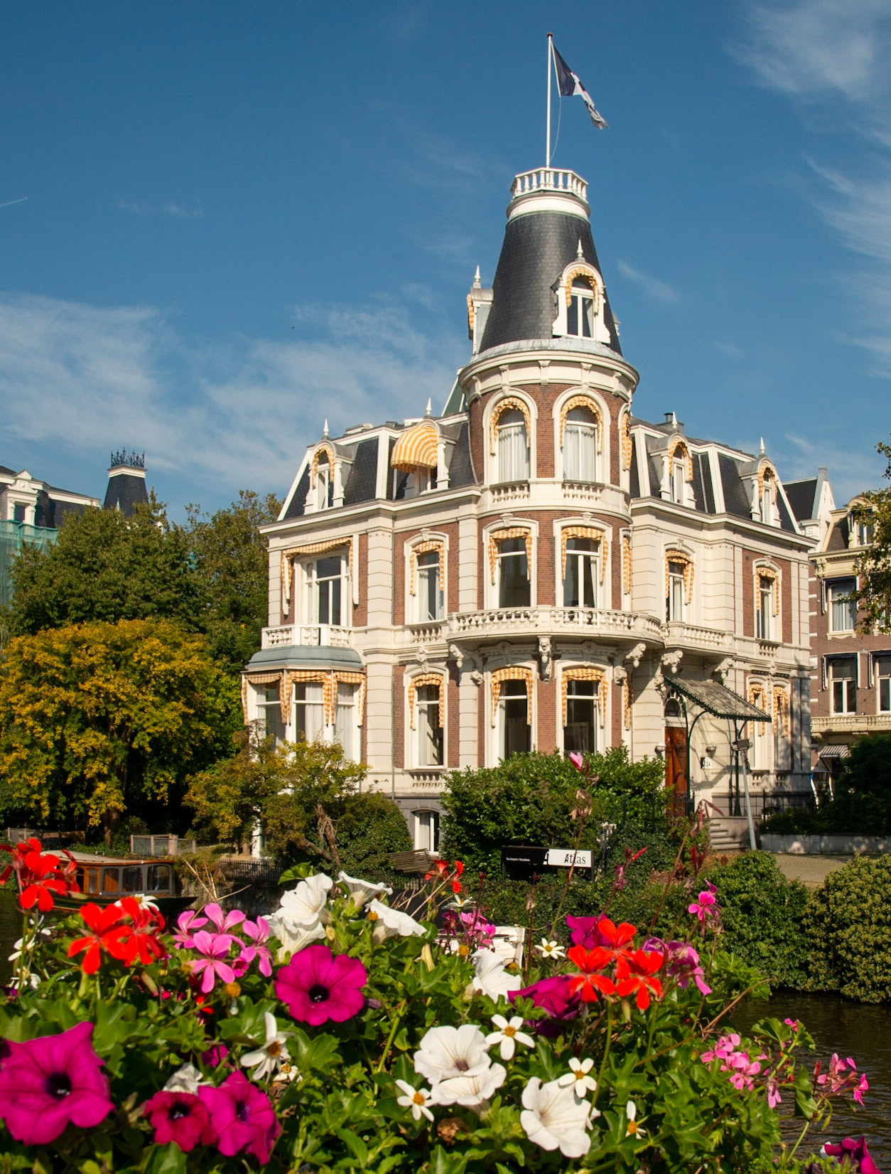 Flowers in front of a building on a canal in Amsterdam, Netherlands