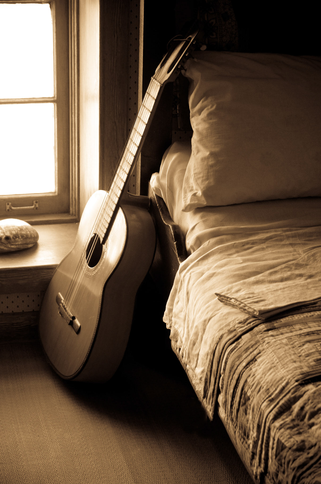Guitar in bedroom of old lighthouse at Cabrillo National Monument, San Diego, California, USA.