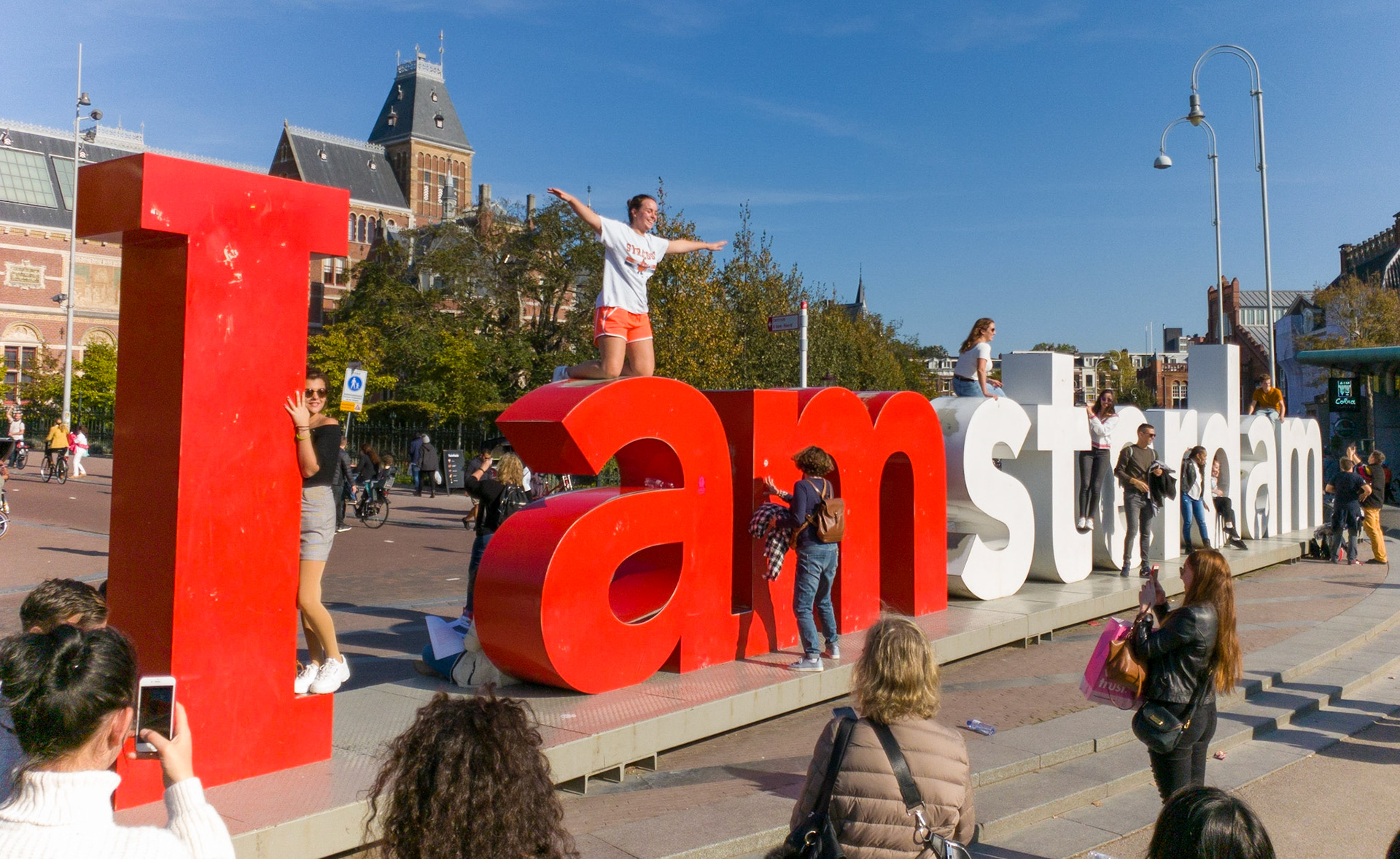People take selfies in front of the I Amsterdam sculpture in Museum Quarter, Amsterdam, Netherlands