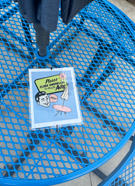 Poster displayed on umbrella table