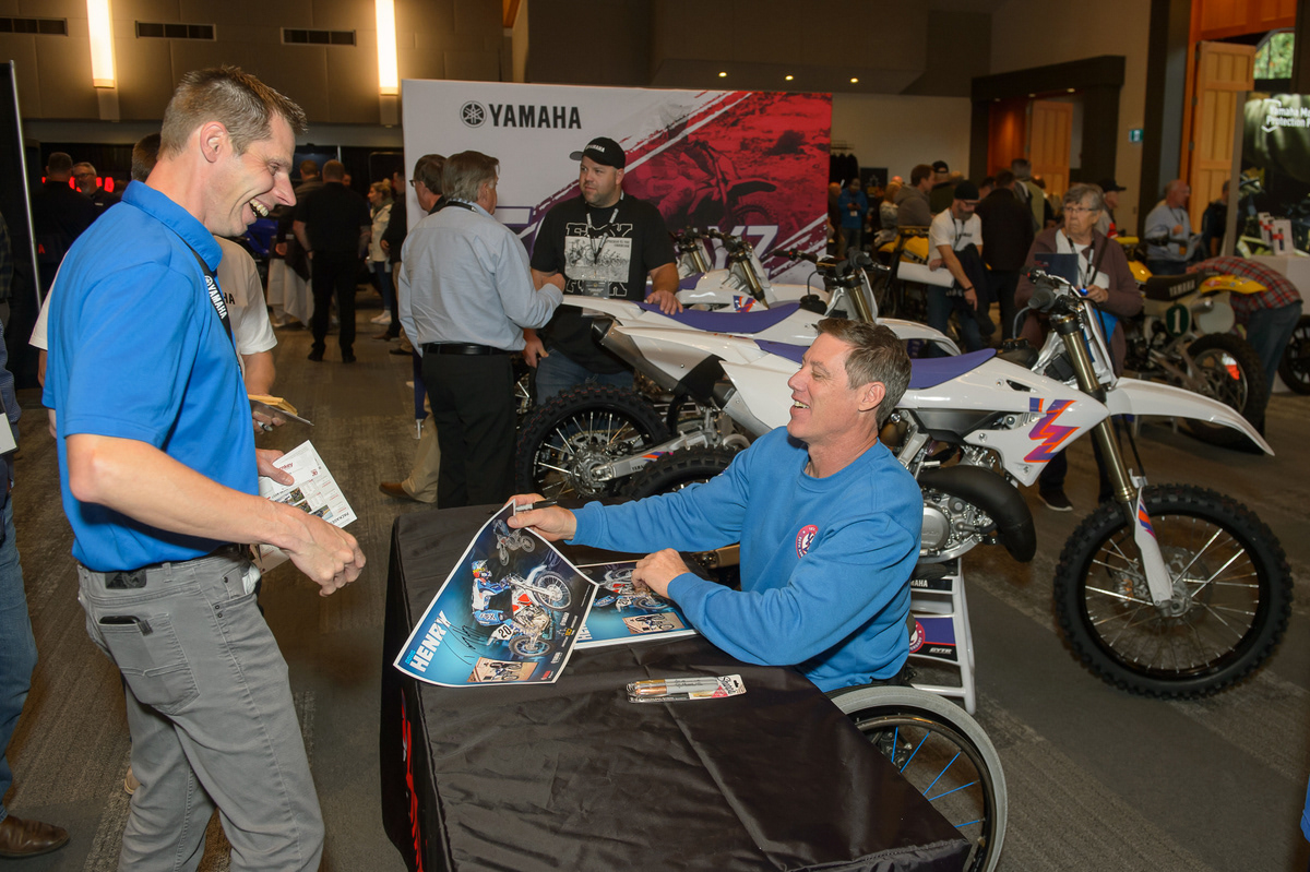 Doug Henry signing his poster at Yamaha Motor Canada Conference - 2023