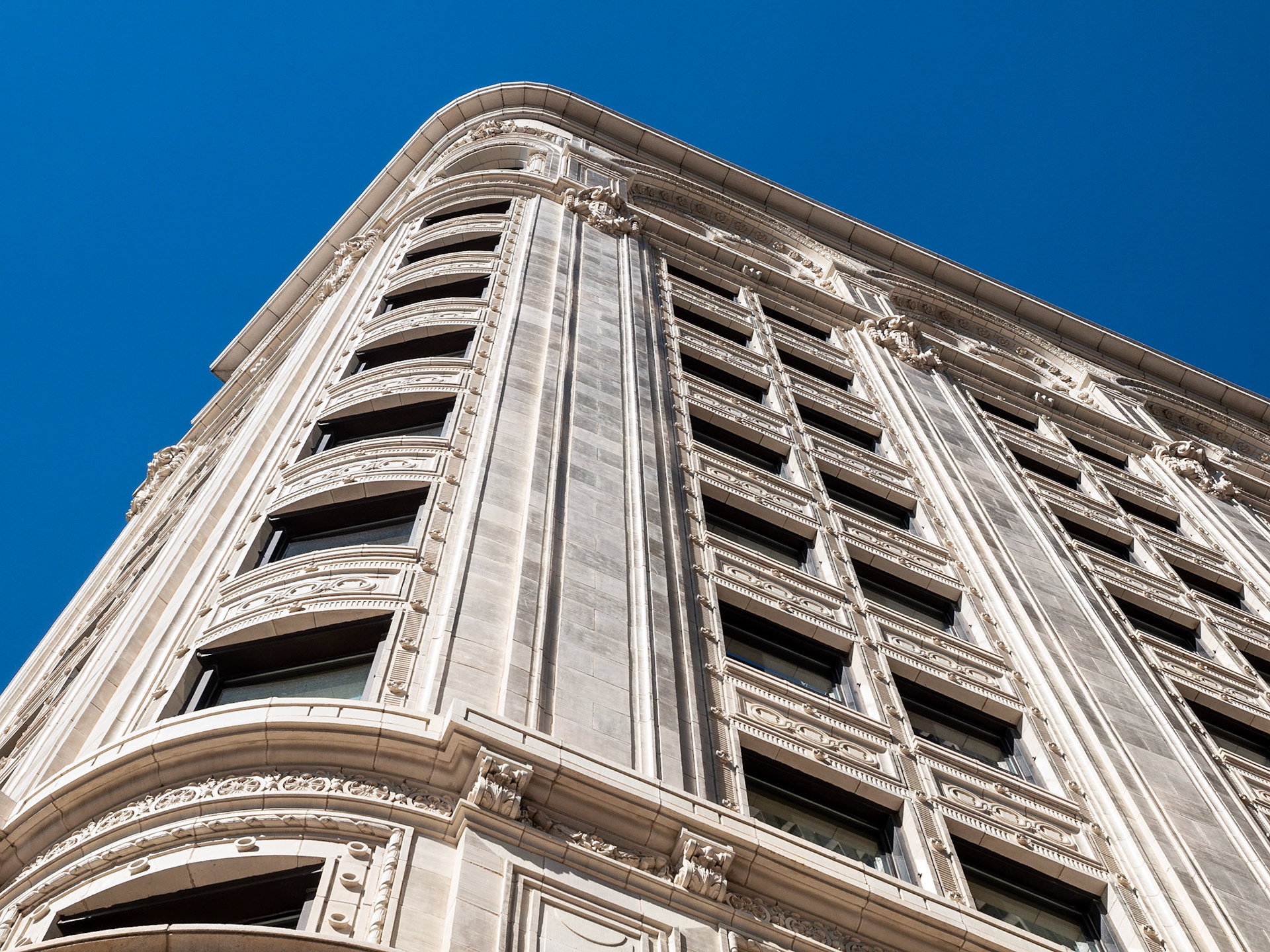 Ornate windows and stone building against a blue sky in The Exchange District, Winnipeg, Manitoba, Canada