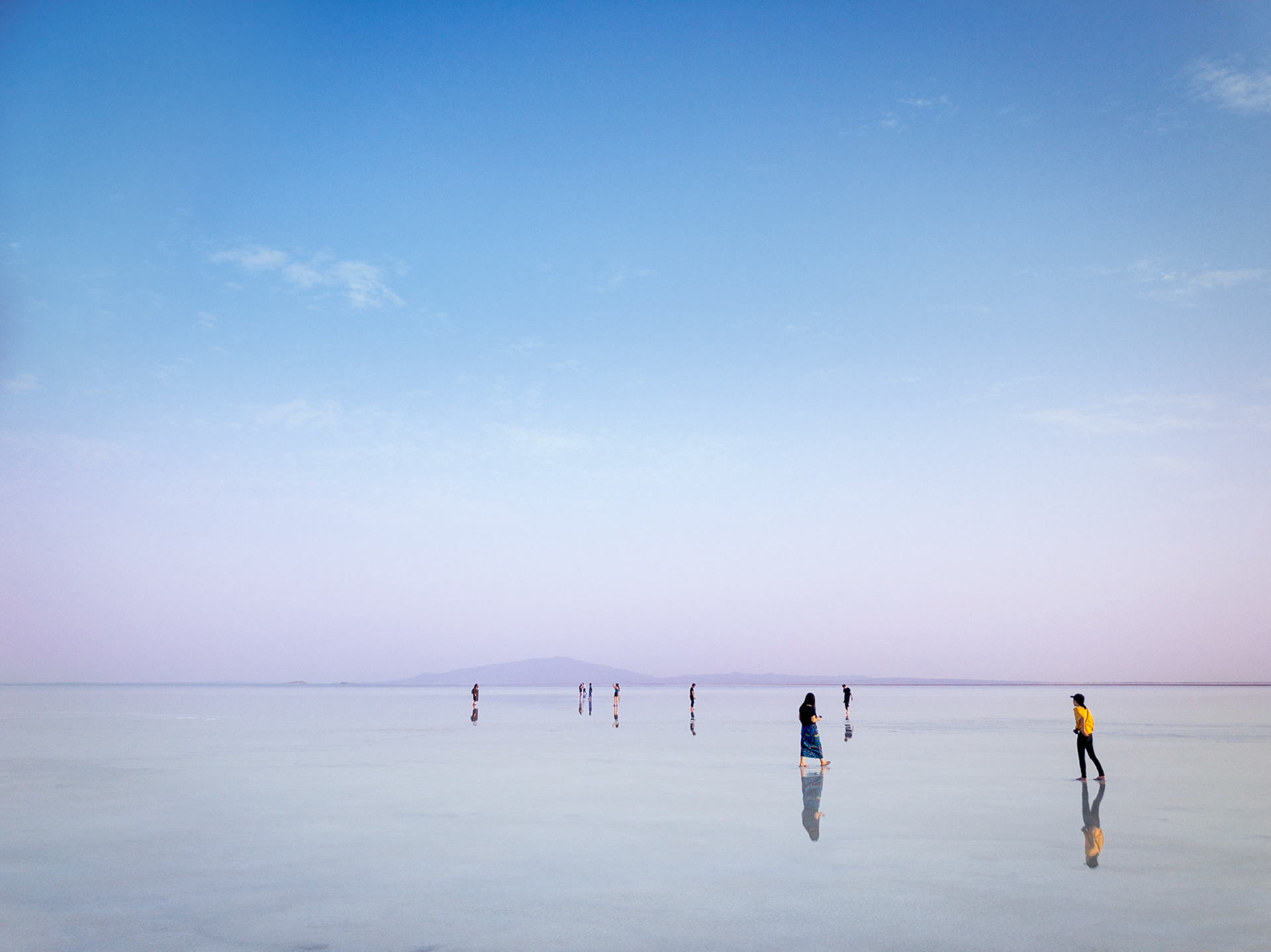 Tourists gather at dusk on the mirror surface of Lake Asale, a huge but very shallow salt lake in Ethiopia's Danakil Depression .