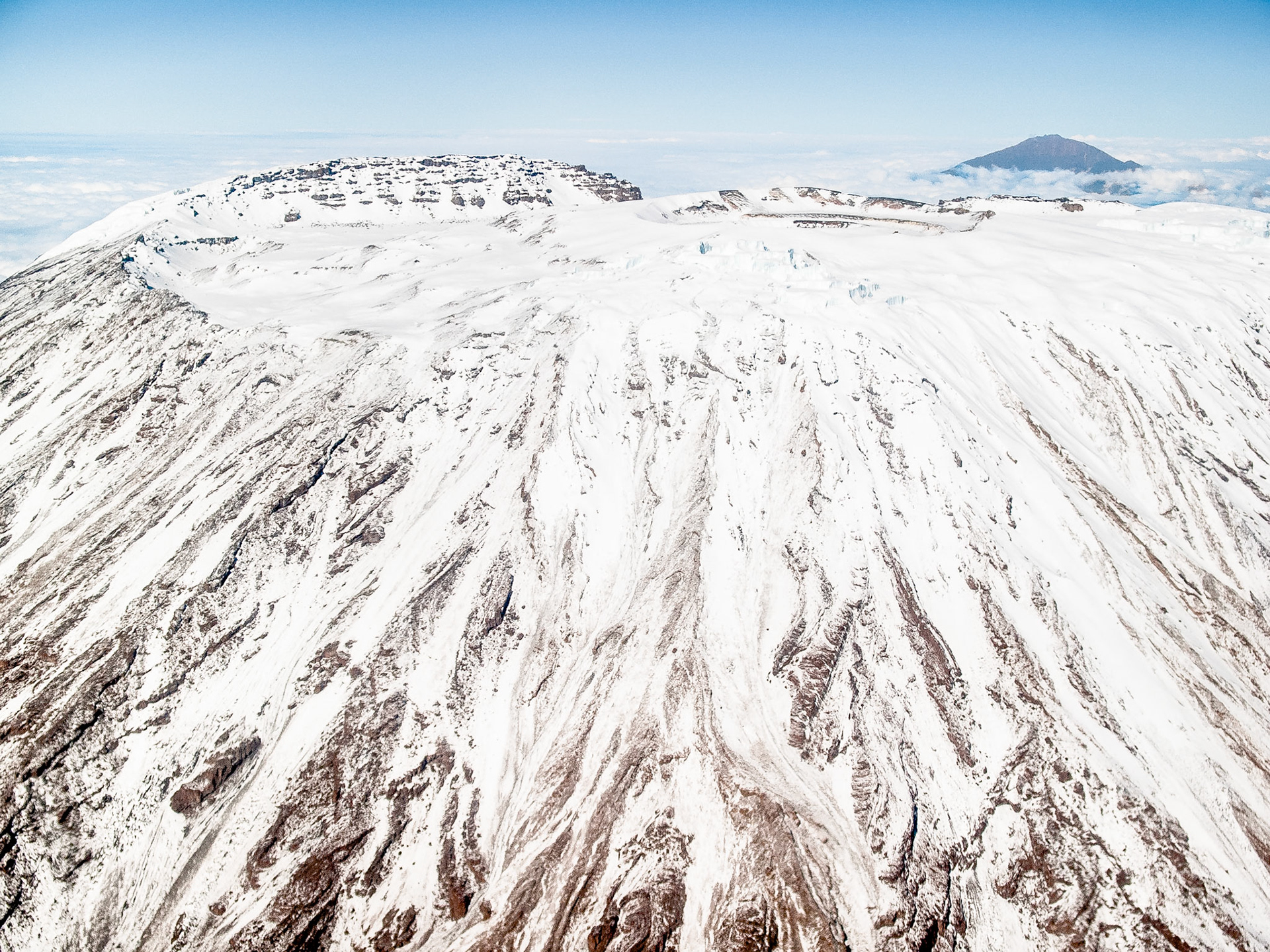 A close-up view from the air of the peak and crater of volcanic Mount Kilimanjaro, Africa's tallest mountain, with Mt Meru 75km in the distance.