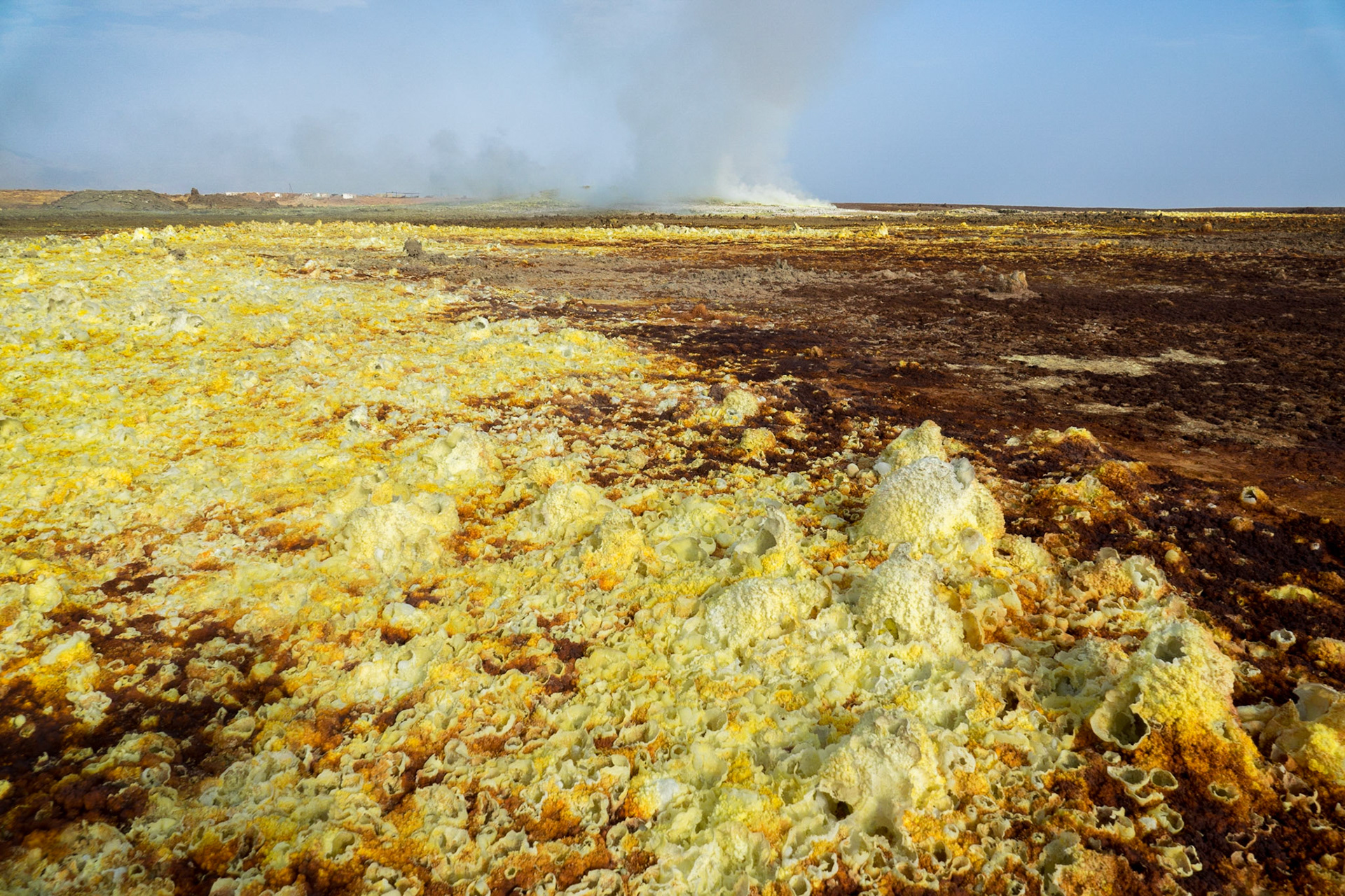 Fumaroles spouting sulphuric acid and gas erupt on the floor of Dallol in Ethiopia’s Danakil Depression, creating yellow and green pools and orange-brown geometric patterns, in the hottest, driest, most inhospitable place on Earth.