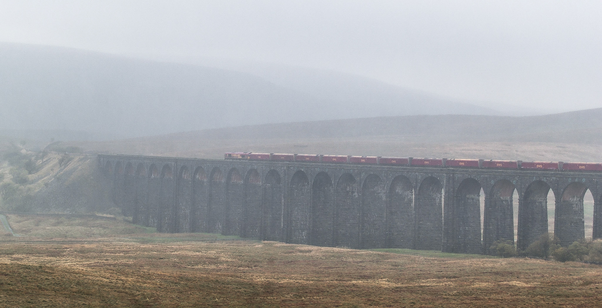 A train heading into the fog over the Ribblehead Viaduct, Yorkshire, England