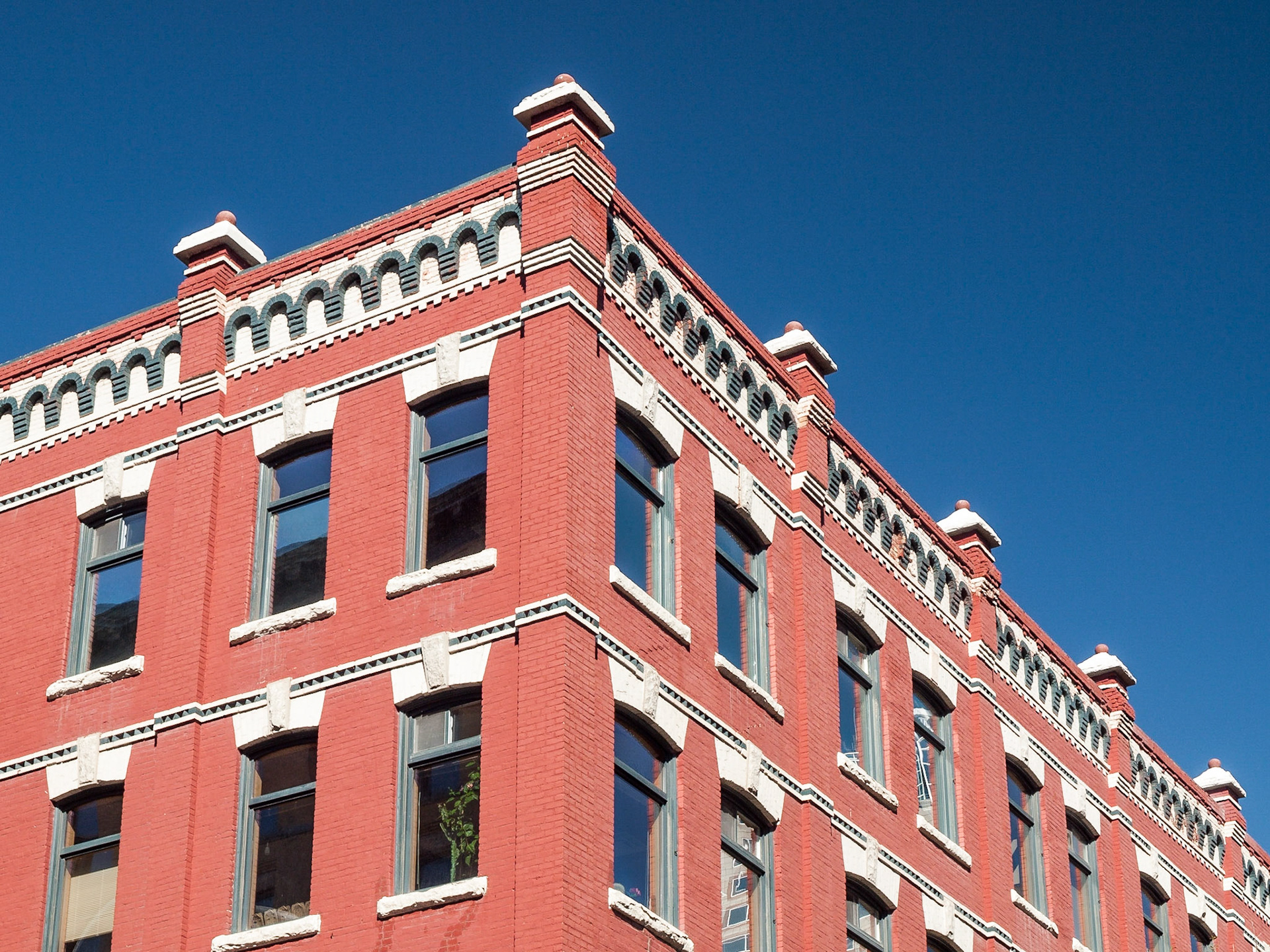 Windows and ornate brickwork of a red brick building in The Exchange District, Winnipeg, Manitoba, Canada