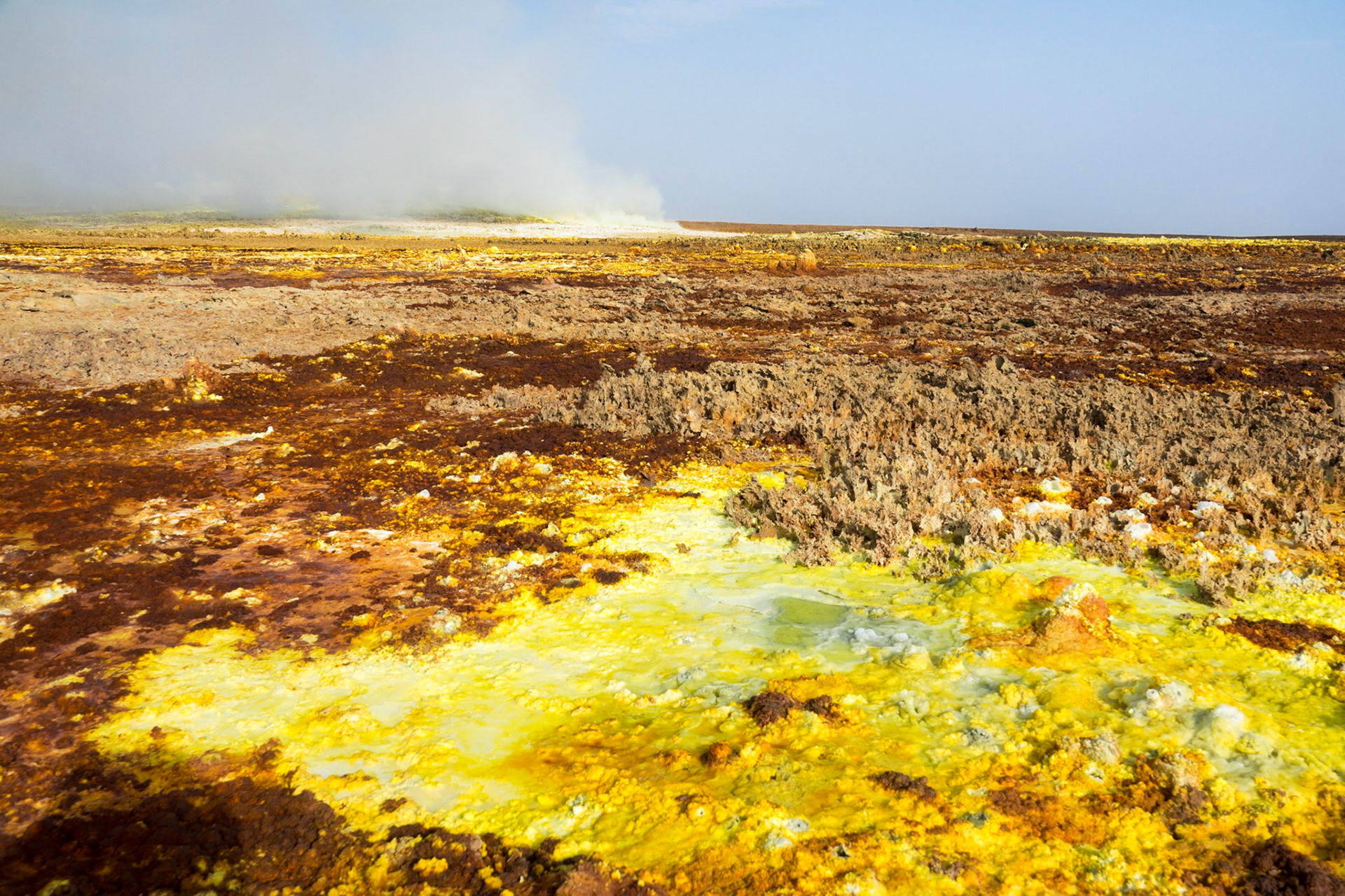 Fumaroles spouting sulphuric acid and gas erupt on the floor of Dallol in Ethiopia’s Danakil Depression, creating yellow and green pools and orange-brown geometric patterns, in the hottest, driest, most inhospitable place on Earth.