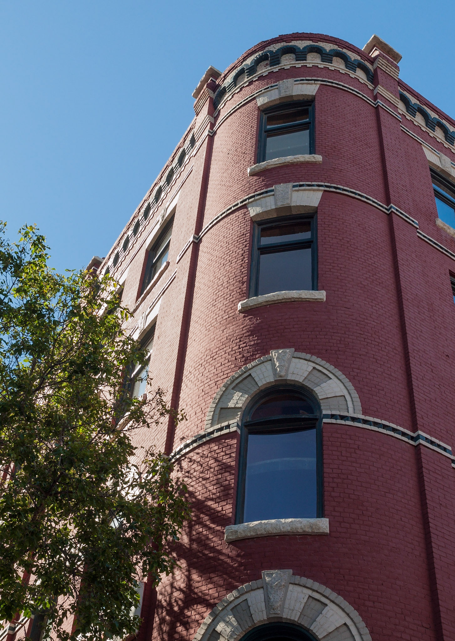 Rounded corner and window of a red brick building in The Exchange District, Winnipeg, Manitoba, Canada