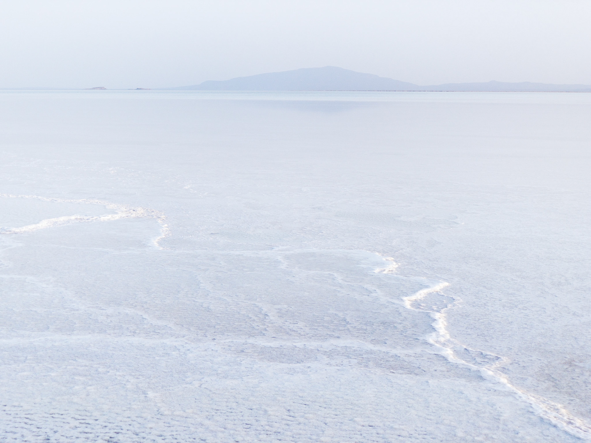 A white ridge of salt snakes its way across Lake Asale in Ethiopia's hot and dry Danakil Depression, the most inhospitable place on Earth.