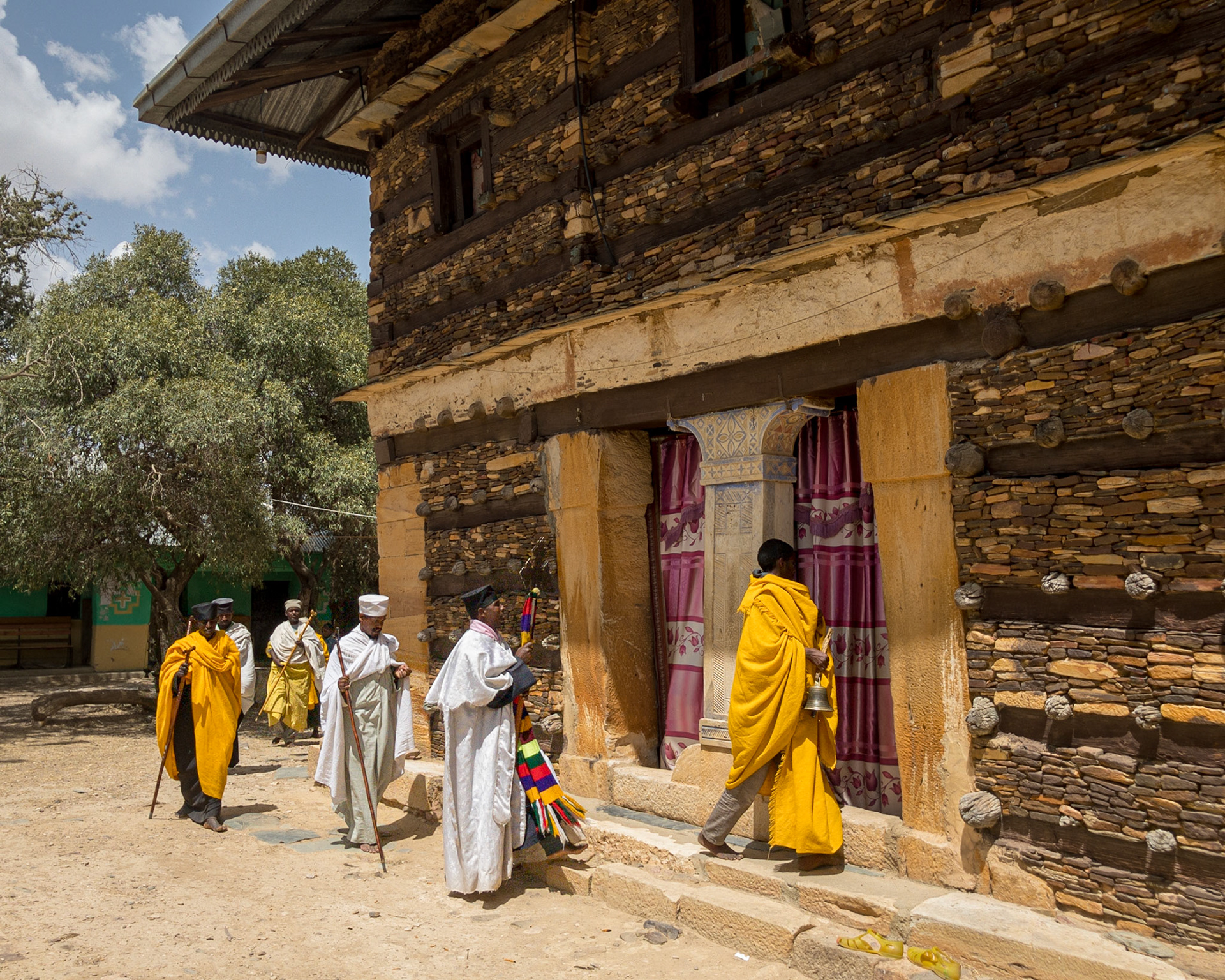 A group of priests finish their circuit of the church at the Debre Damo Monastery, Tigray, Ethiopia