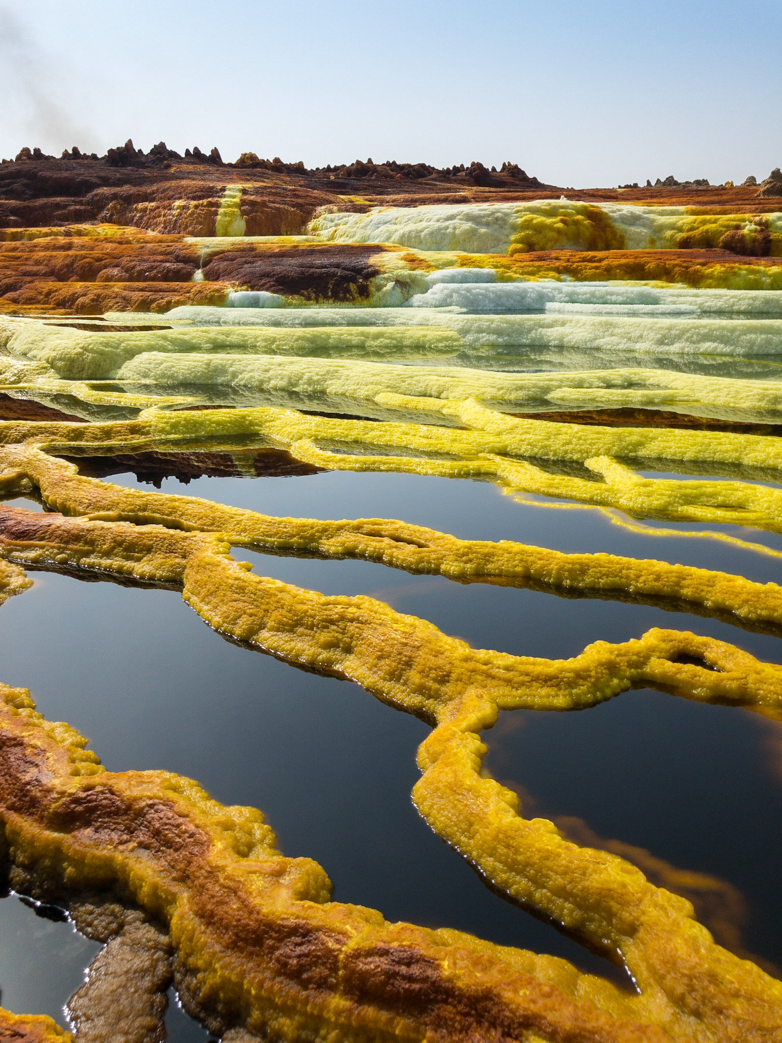Green, orange and yellow pools of saline, sulphuric acid, formed from hydrogen thermal activity at Dallol in Ethiopia’s Danakil Depression, the hottest, driest, most inhospitable place on Earth.