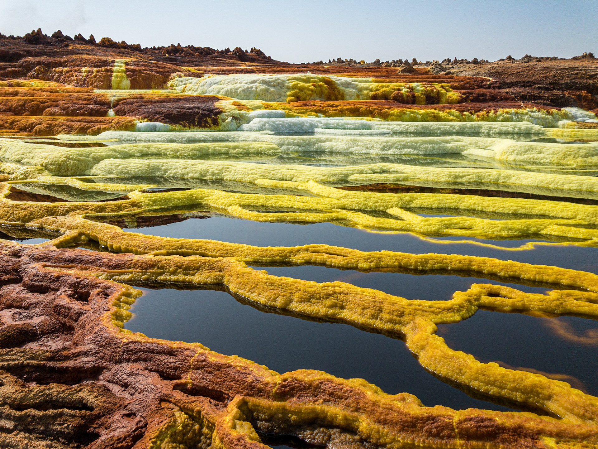 Green, orange and yellow pools of saline, sulphuric acid, formed from hydrogen thermal activity at Dallol in Ethiopia’s Danakil Depression, the hottest, driest, most inhospitable place on Earth.