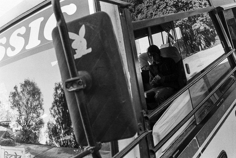 A local bus driver counts his earnings after a long day's ride.