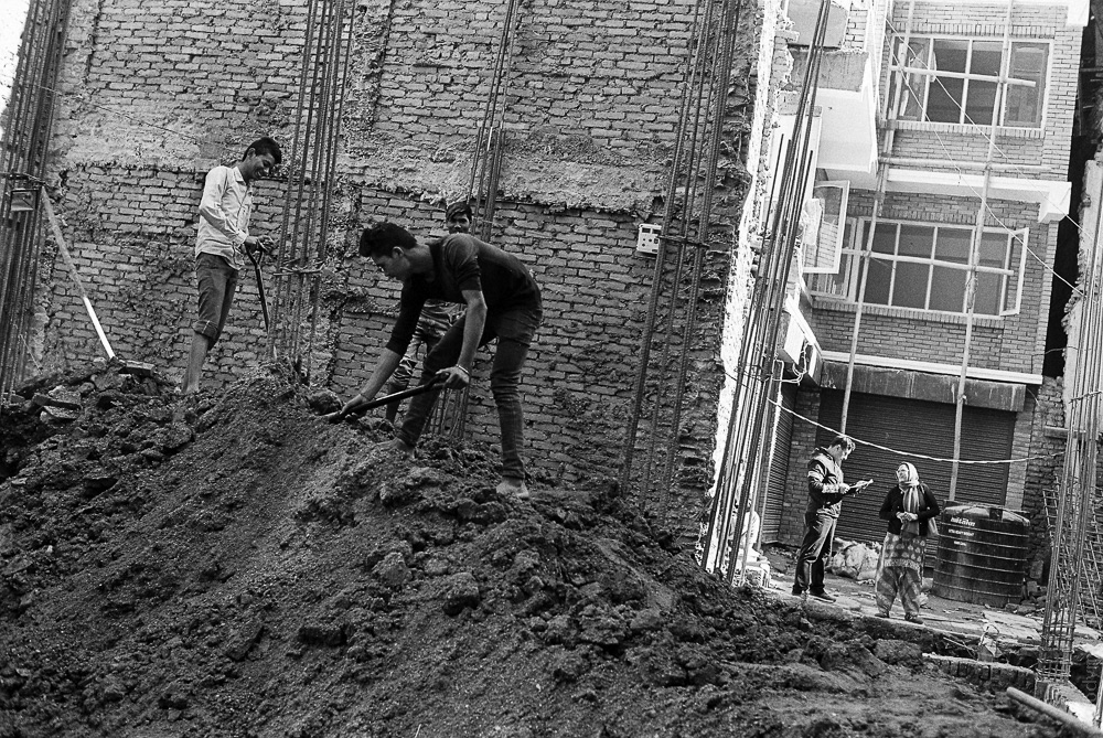 Construction workers building a new house in Kathmandu city center, as part of the ongoing effort to rebuild what was destroyed during the 2015 earthquake.