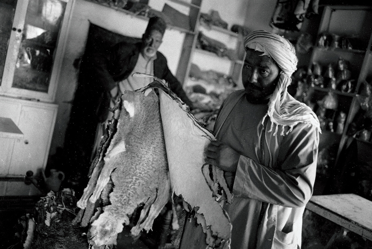 A vendor proudly displays his collection of furs and karakul pelts, a key ingredient in traditional men's hats.
