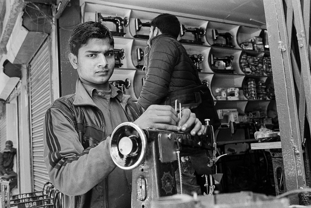 Old is gold: A sewing machine repairman works on a classic, fully-mechanical sewing machine, despite the advancements in the tailoring industry. These machines may be outdated, but their reliability and sturdiness keep them in use.