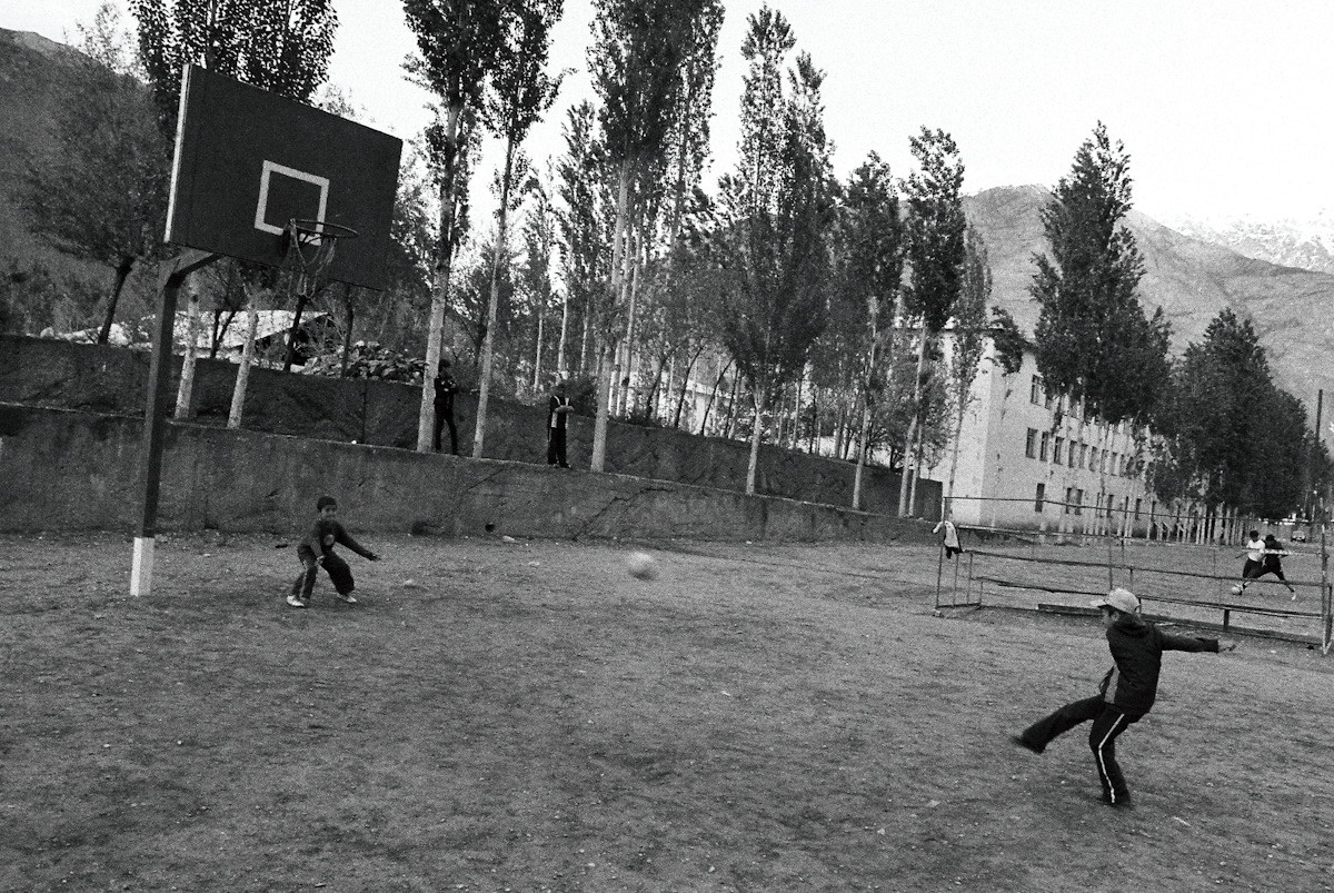 Children play football in a playground in Khorog, Tajikistan, just a stone's throw away from the border with neighboring Afghanistan, reminding us that even in areas of tension, simple joys and playful moments can be found.