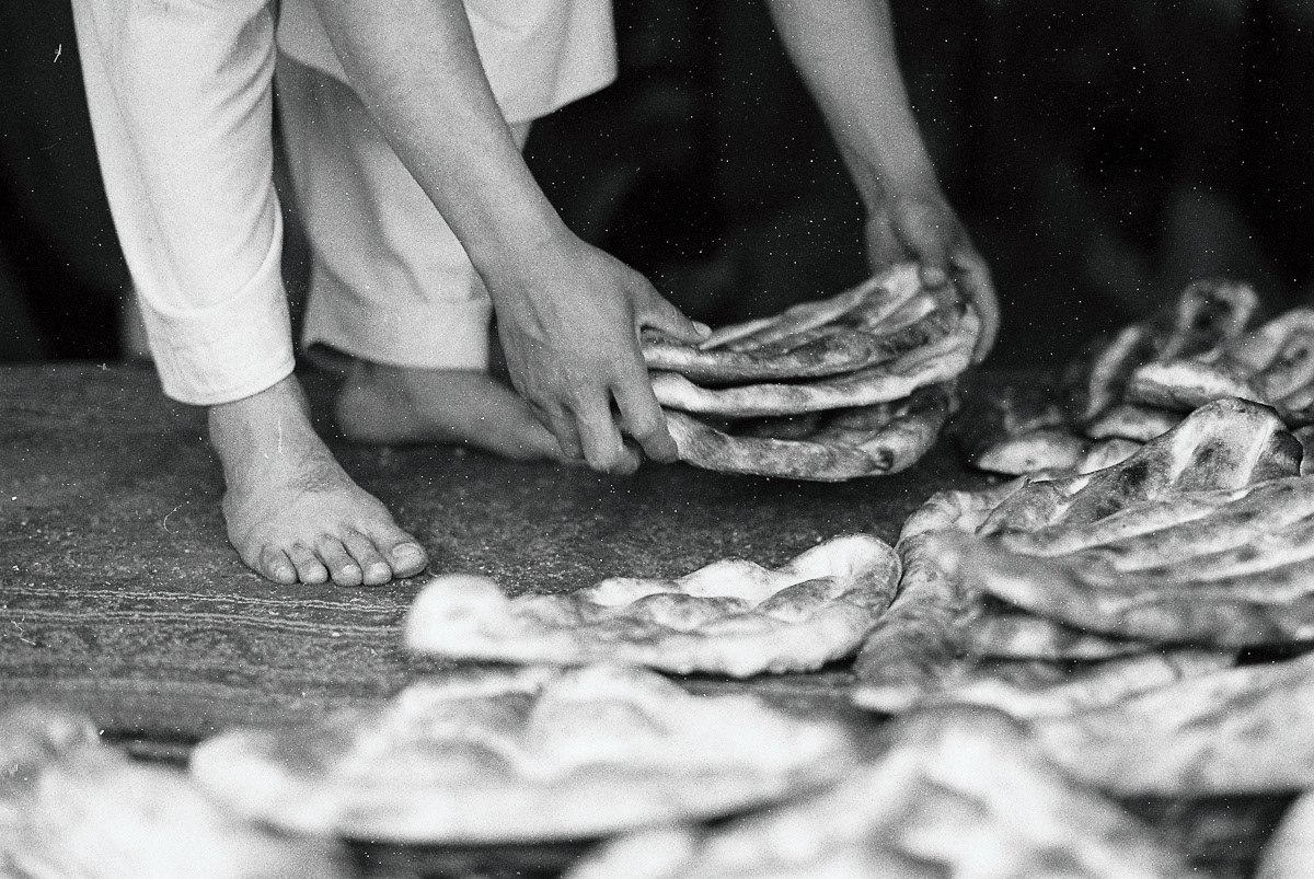 The traditional tandoori bread baking process, Kabul.