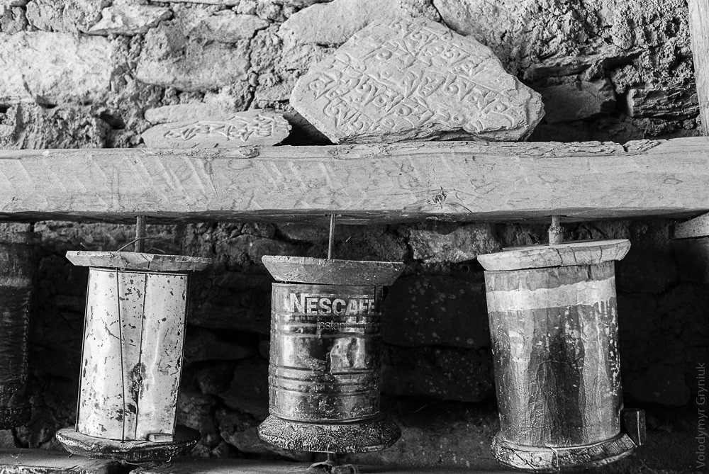 A creative take on Buddhist prayer drums, crafted from a combination of wood barrels and repurposed Nescafe cans.