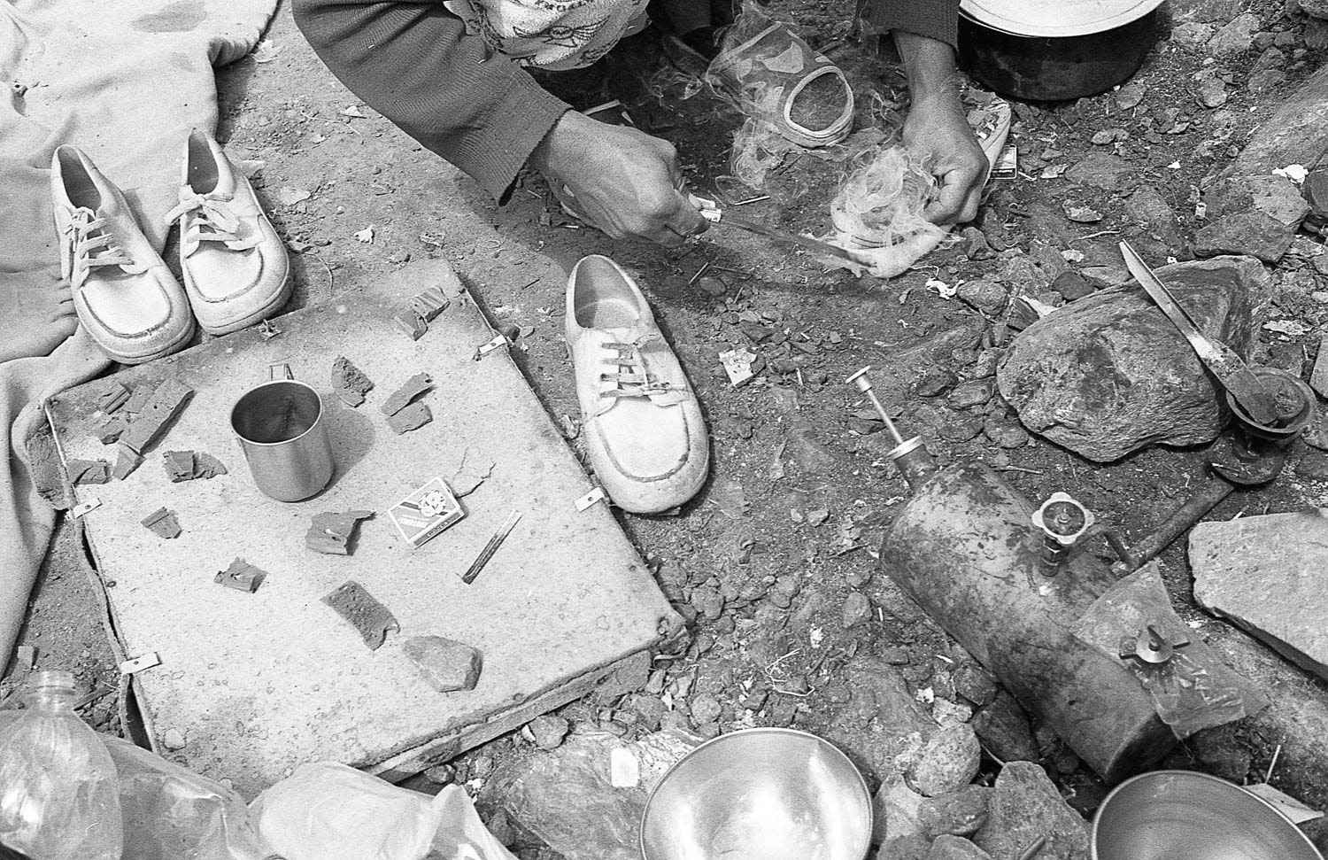 To prepare for the climb up Gondogoro La pass, porters creates improvised crampons by attaching pieces of rubber foam to their soles.