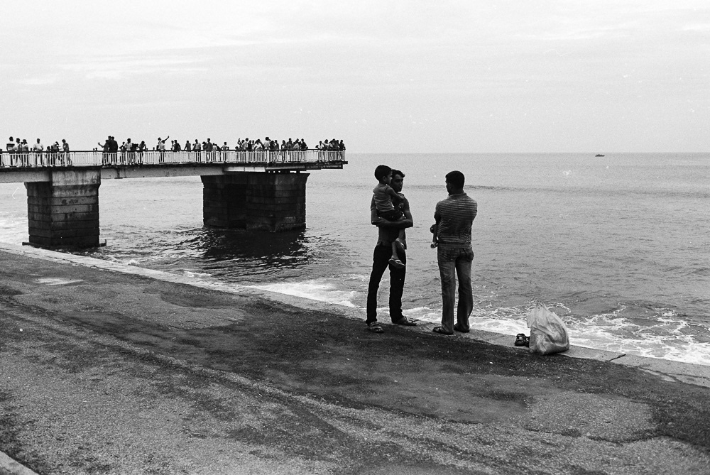 People enjoy a leisurely walk along the only walking street on Colombo's shoreline.