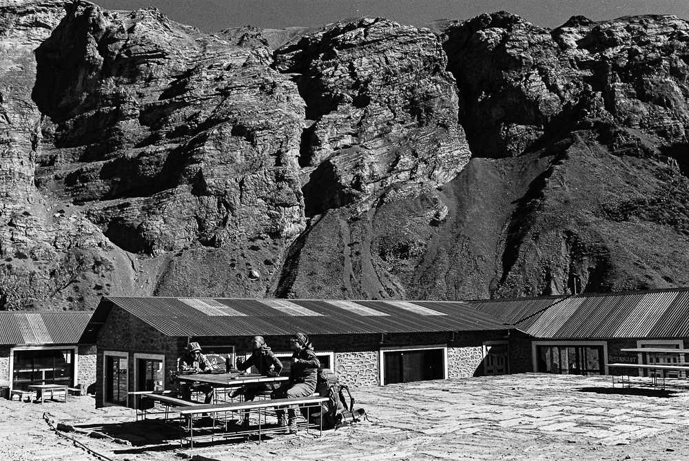 Tired trekkers rest at a teahouse before beginning the tough climb up Torong La pass.