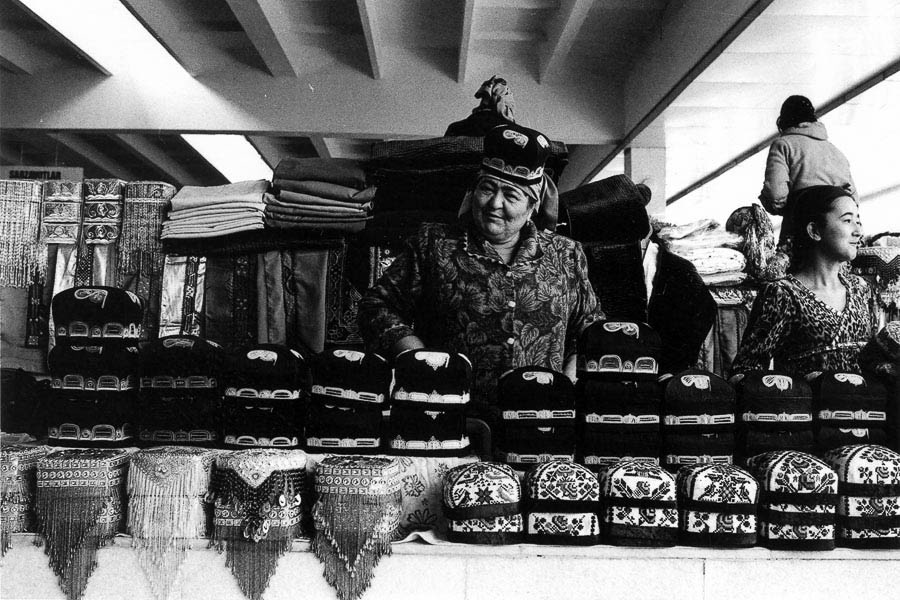 Samarkand market, vendor proudly displays his collection of traditional hats.
