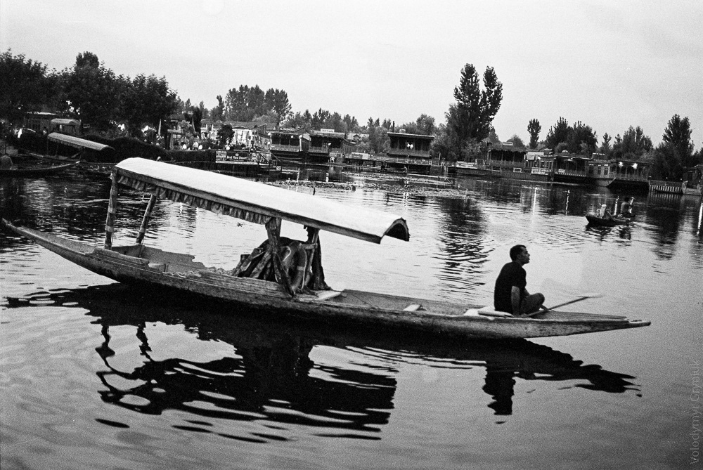 A traditional Kashmiri Shikara boat glides across the surface of the Dal Lake, often referred as the "Diamond in the Crown of Kashmir."