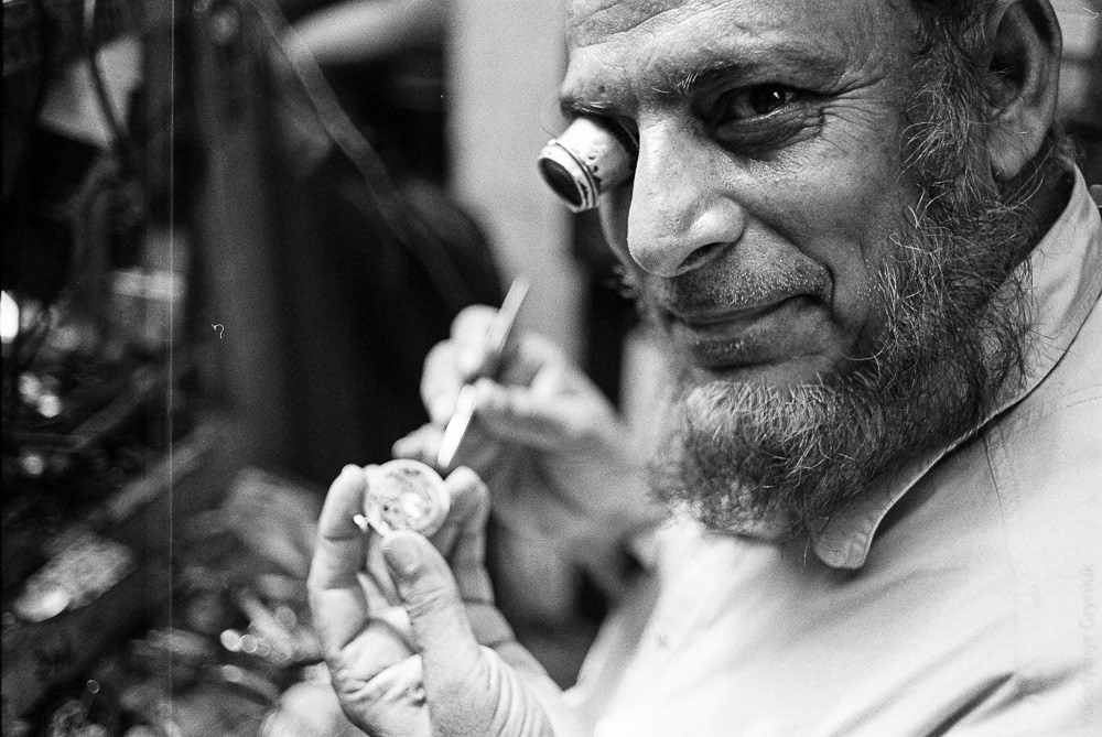 In the central market of Delhi, a skilled watchmaker diligently practices his craft.