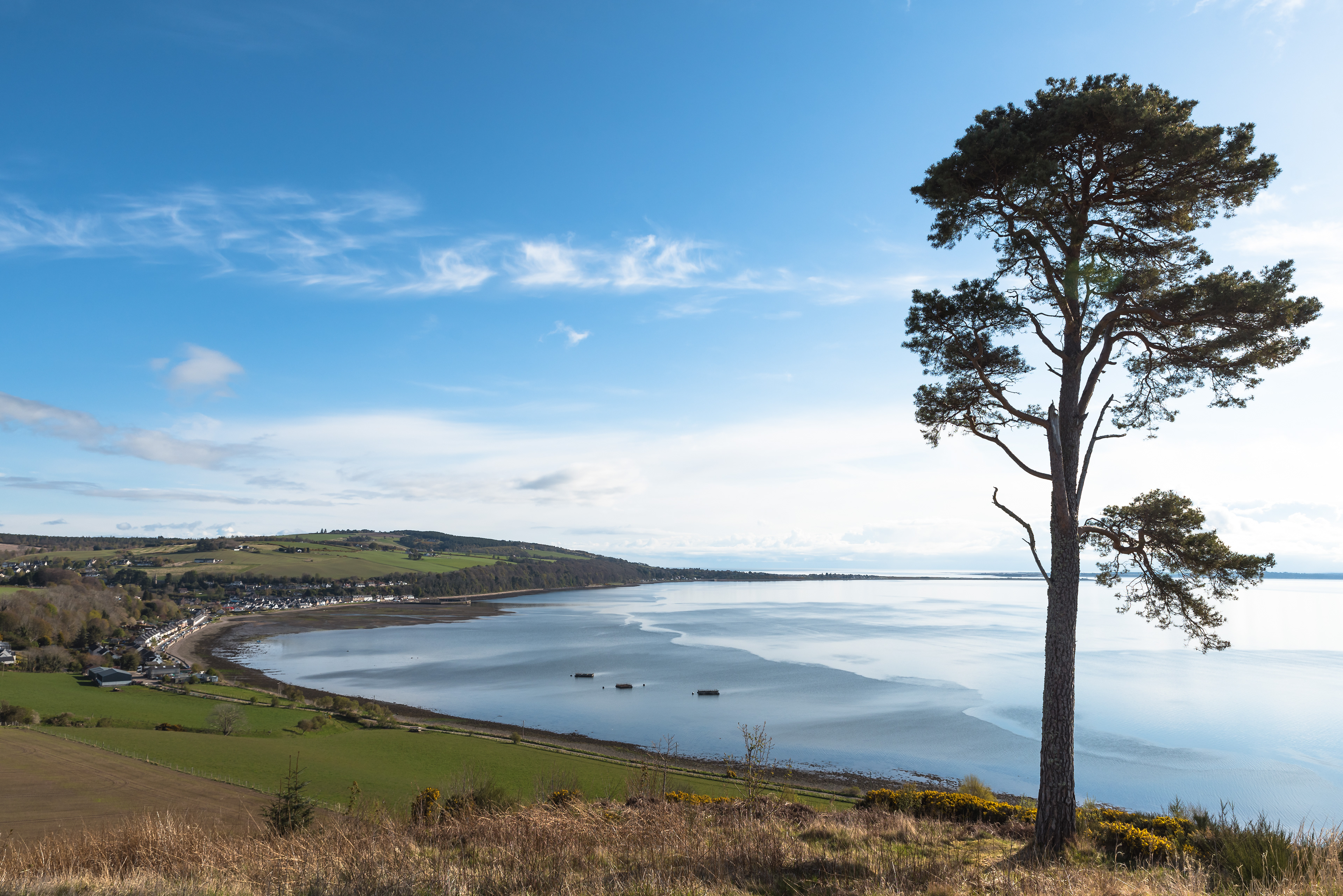 Standing on Ormond Hill on the Black Isle looking out over the small village and harbour at Avoch, with the Moray Firth, Fortrose and the North Sea in the distance