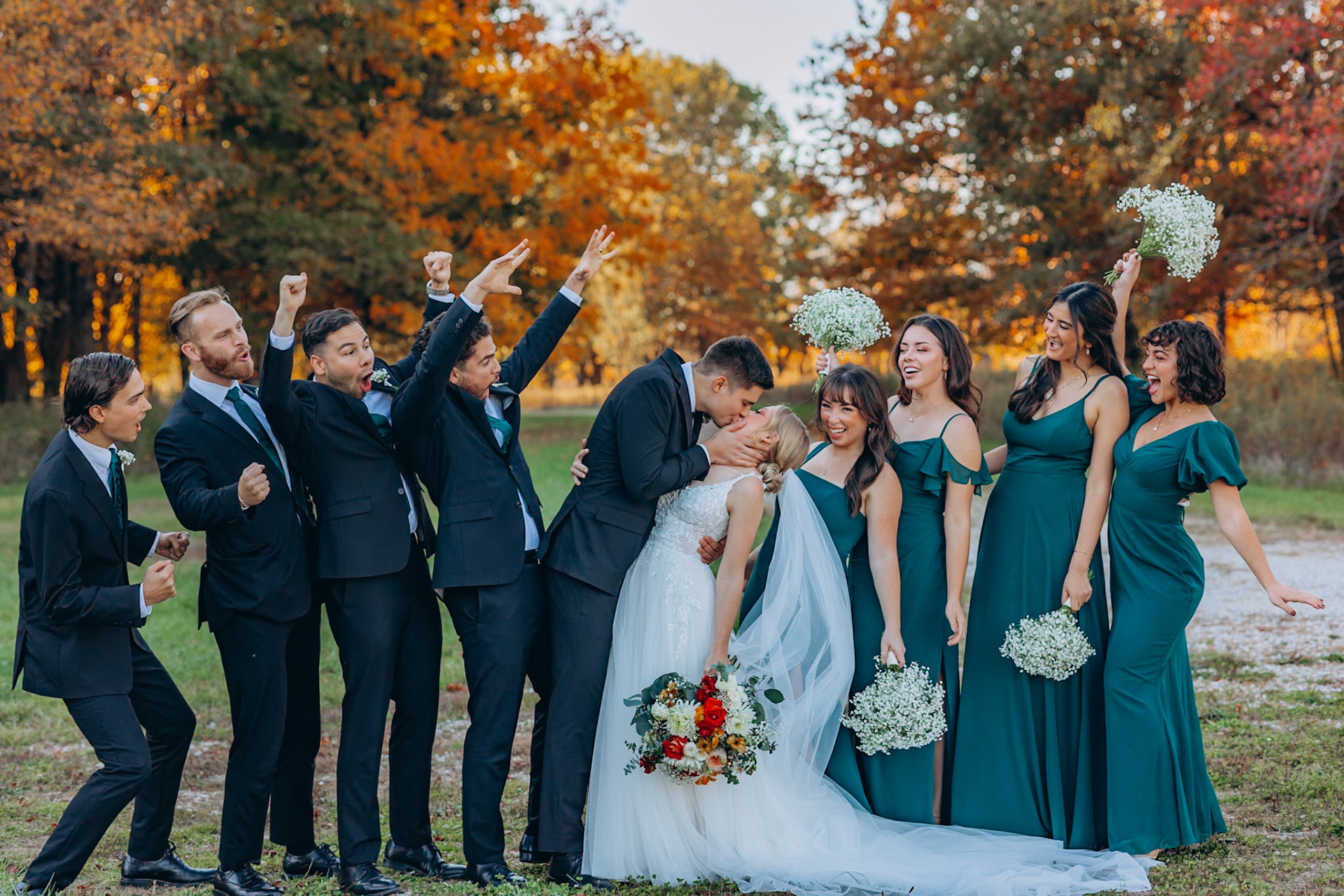 bridal party cheering for the bride and groom